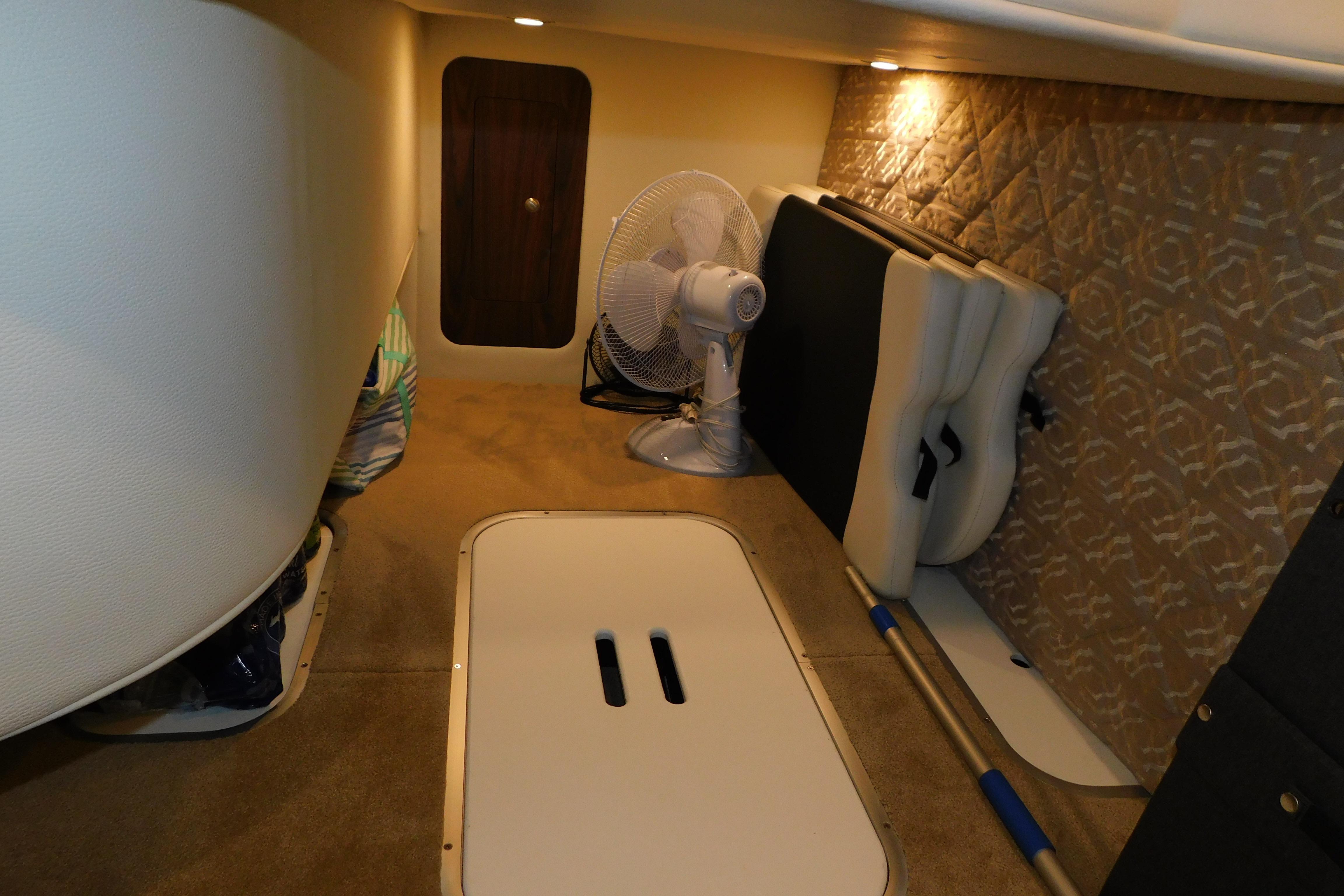 2017 Rinker EX 320 cabin interior with fan and storage compartments.