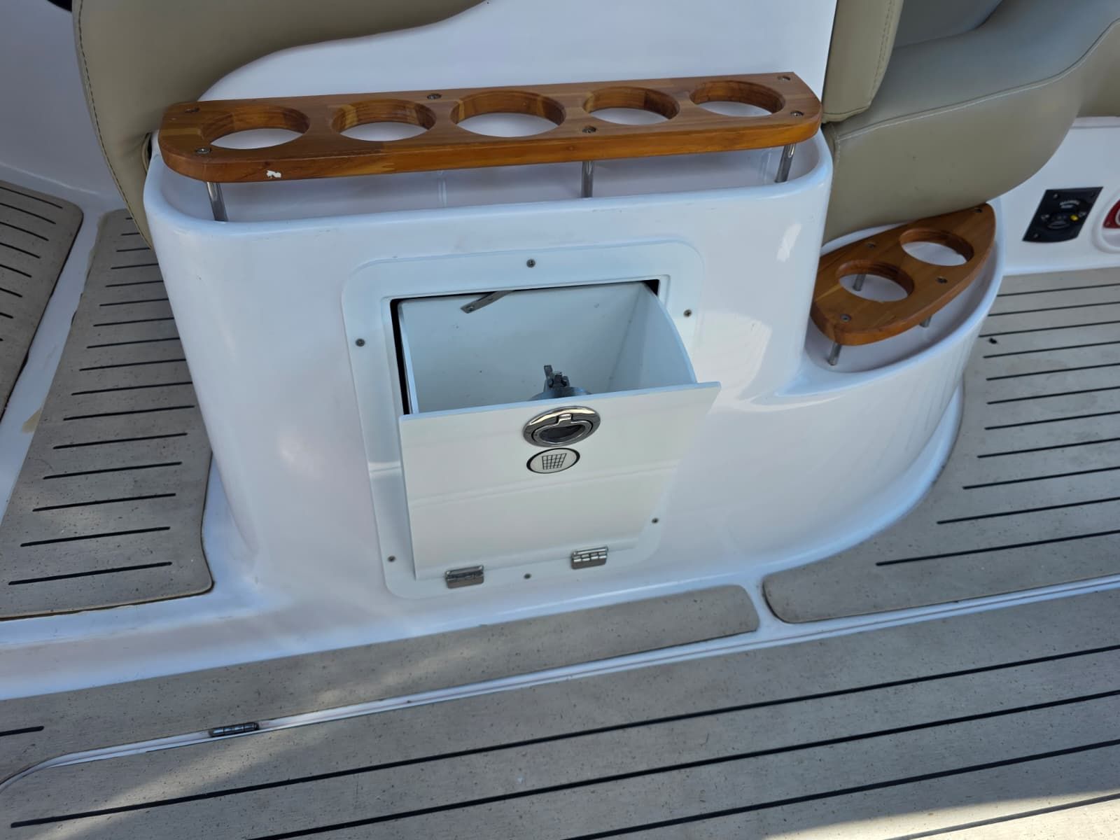 A section of the cockpit with cup holders and a small storage compartment.