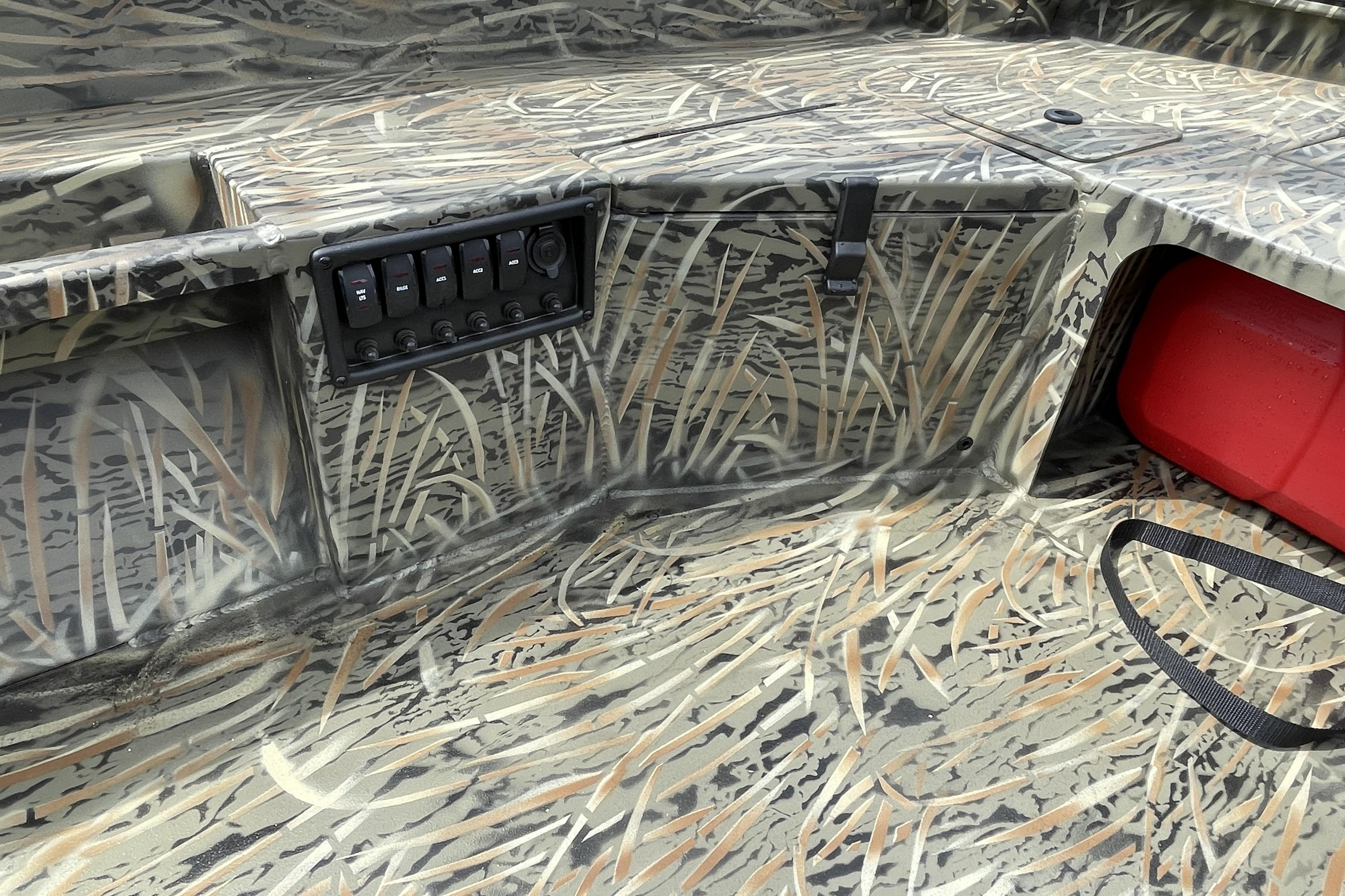 2026 Tracker Grizzly 1756 T Marsh boat interior with camouflage design and control panel.