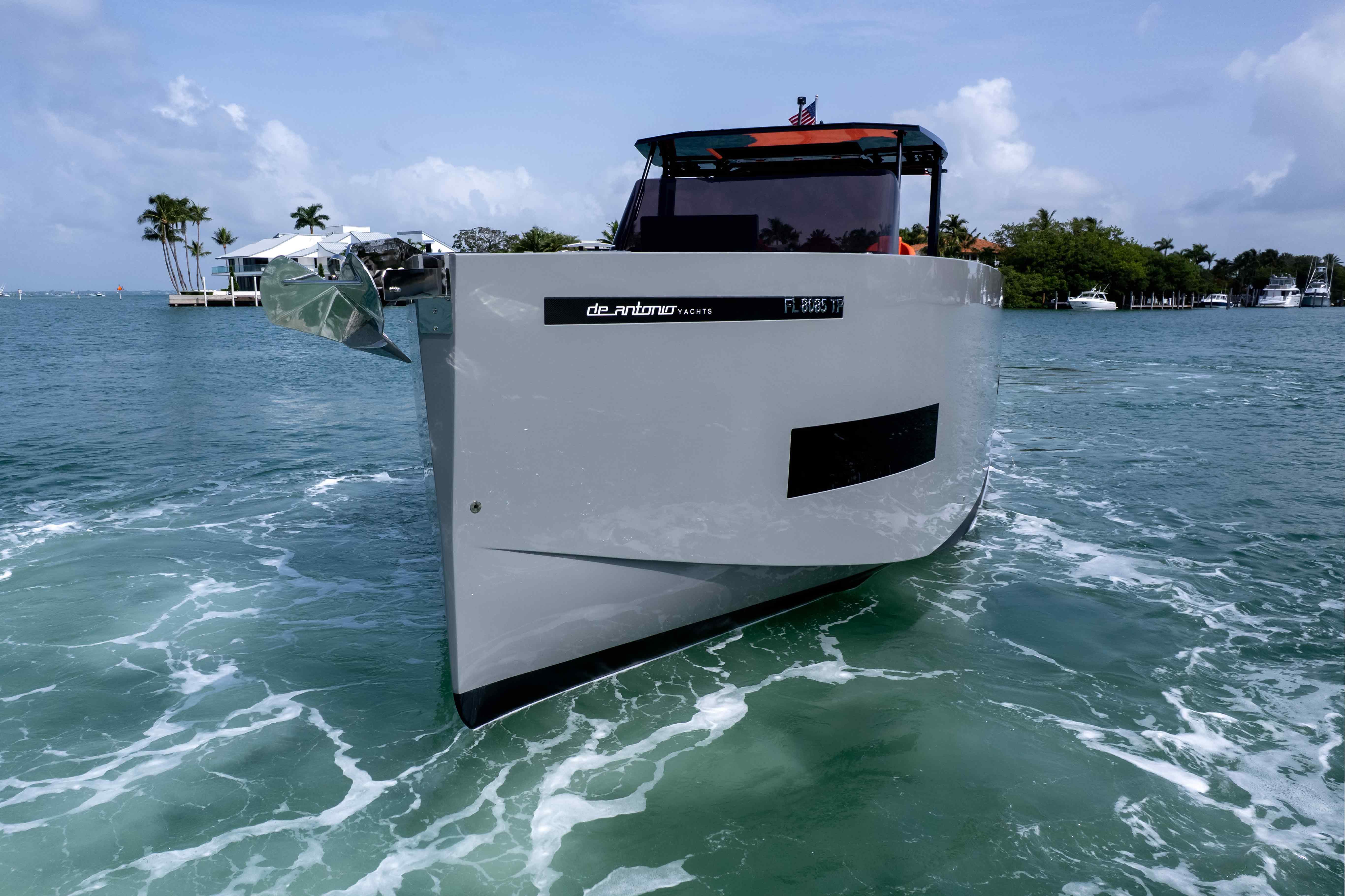 2023 De Antonio Yachts D50 cruising on turquoise waters under a clear sky.