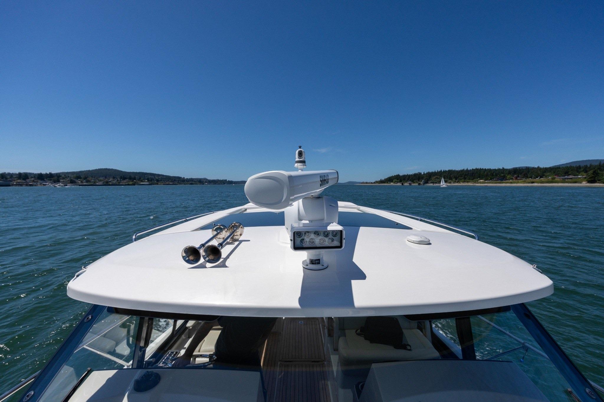 2023 Boston Whaler 405 Conquest cruising on a sunny day, showcasing sleek design and advanced radar.
