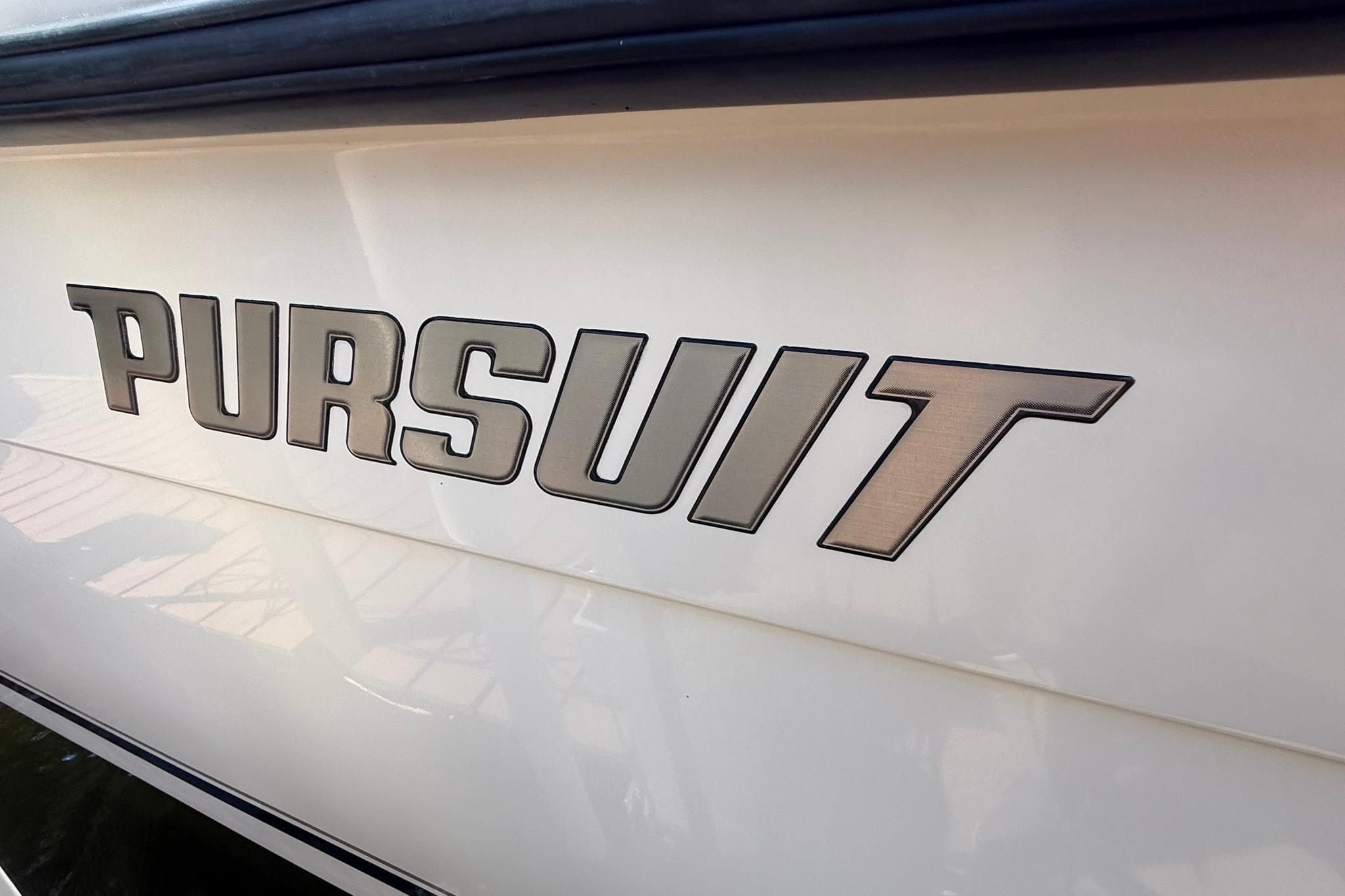 2003 Pursuit 2870 Walkaround boat logo on white hull.