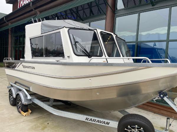 2024 Spartan 215 Athens boat on Karavan trailer, displayed outdoors.