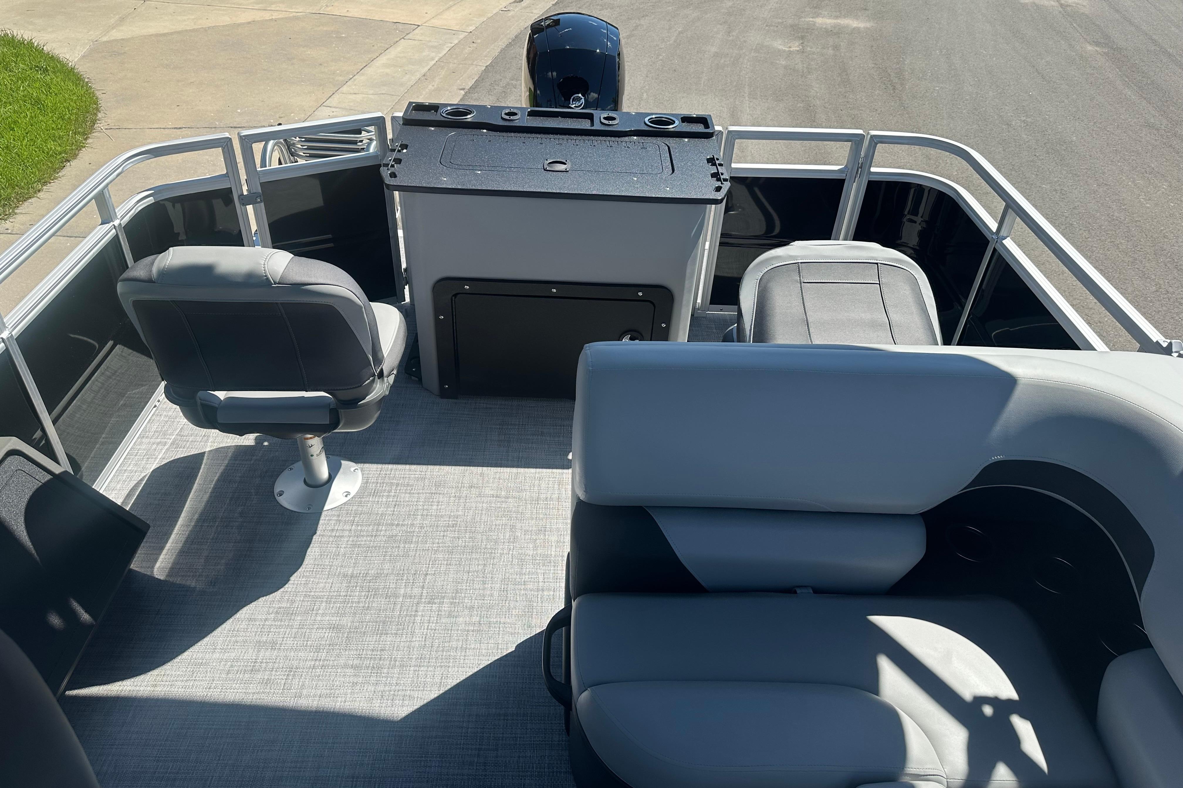 2026 Sun Tracker SportFish 22 DLX pontoon boat interior with seating and helm.