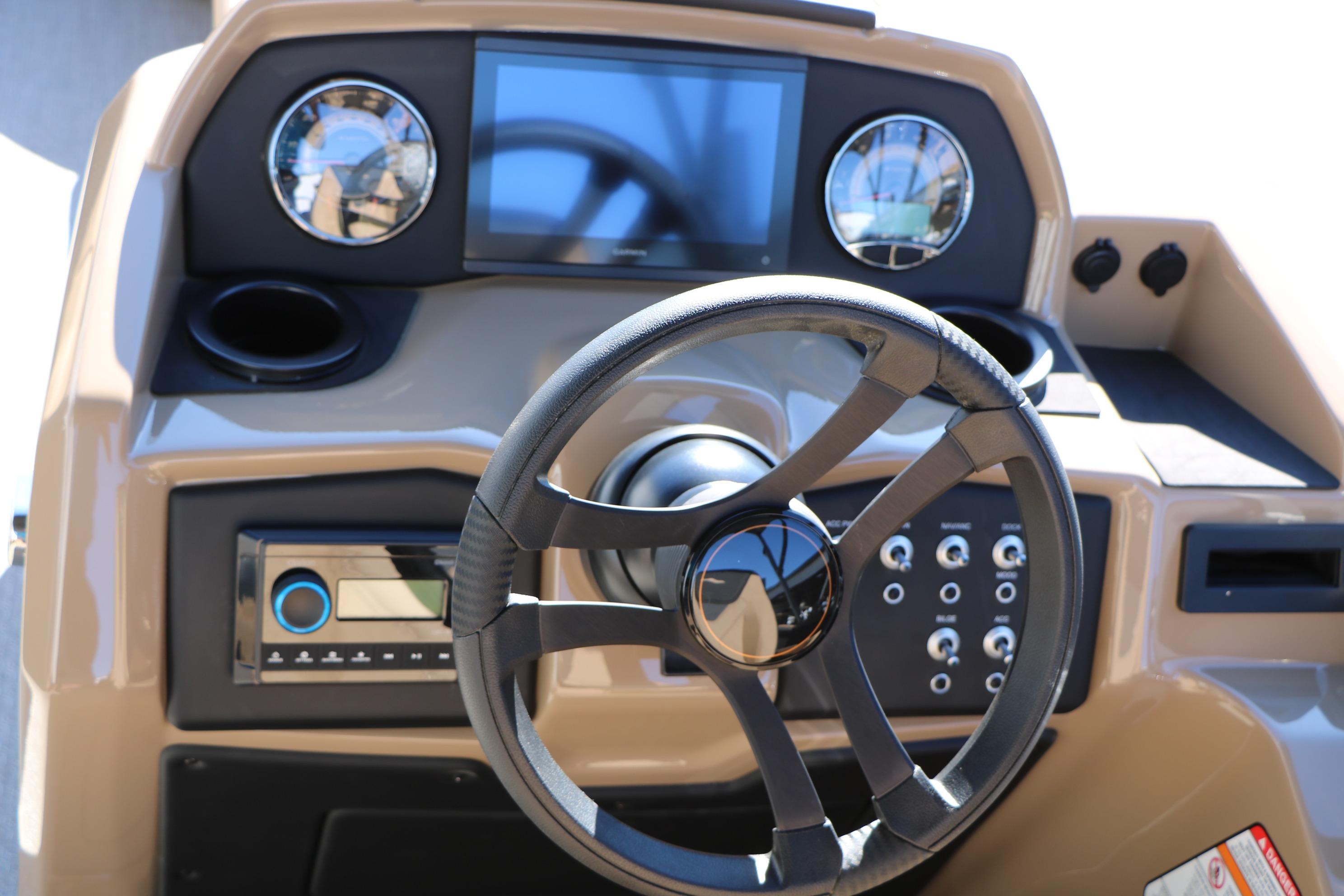 Steering console of 2026 Evotti 525 QL Tri-Toon boat with modern controls and gauges.