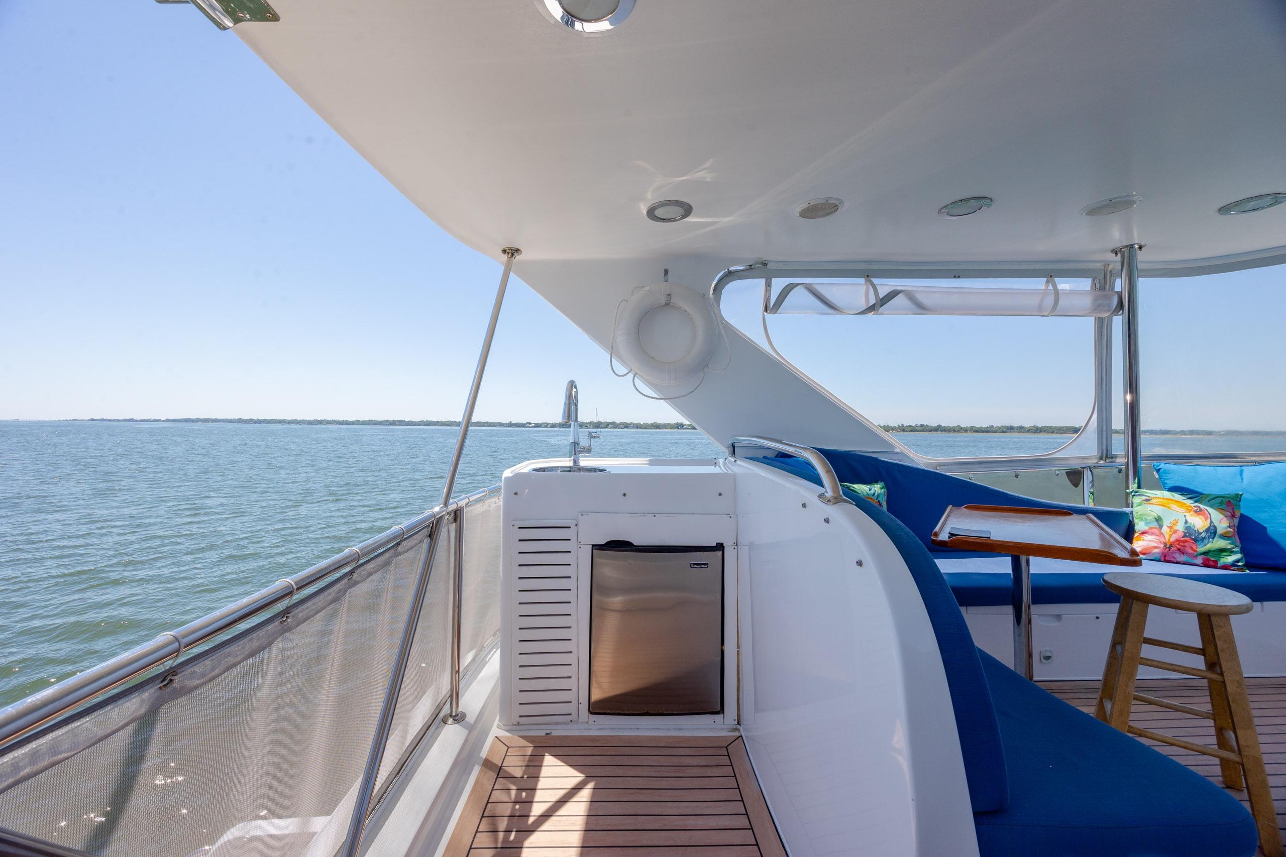 Luxurious 2005 Ocean Alexander 52 Sedan yacht deck with seating and ocean view.