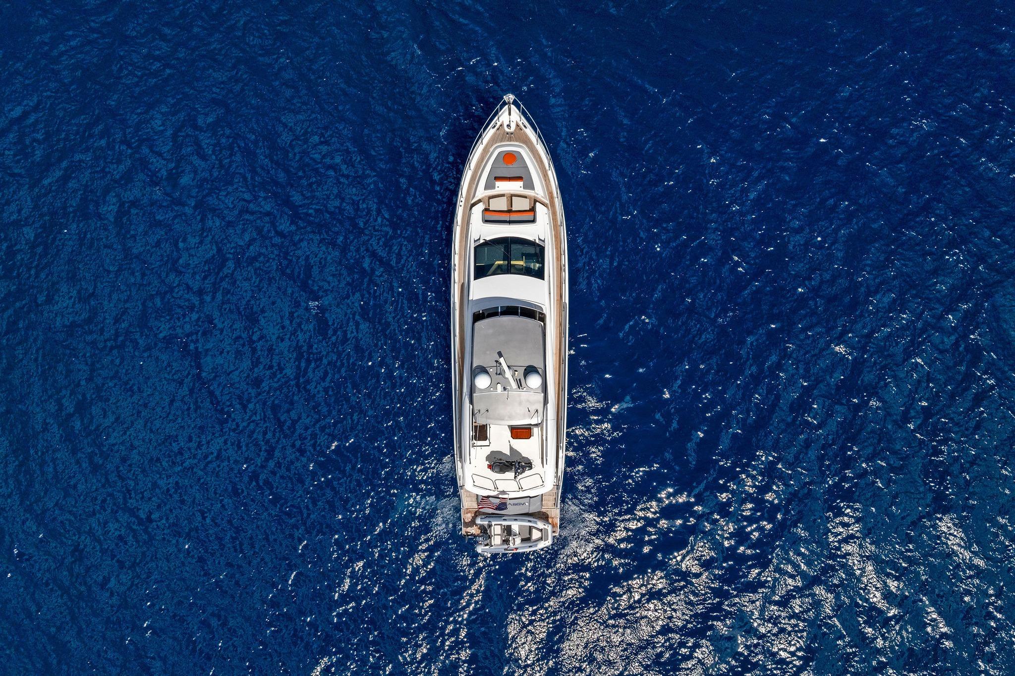 Aerial view of 2014 Lazzara 64 yacht cruising on deep blue ocean waters.