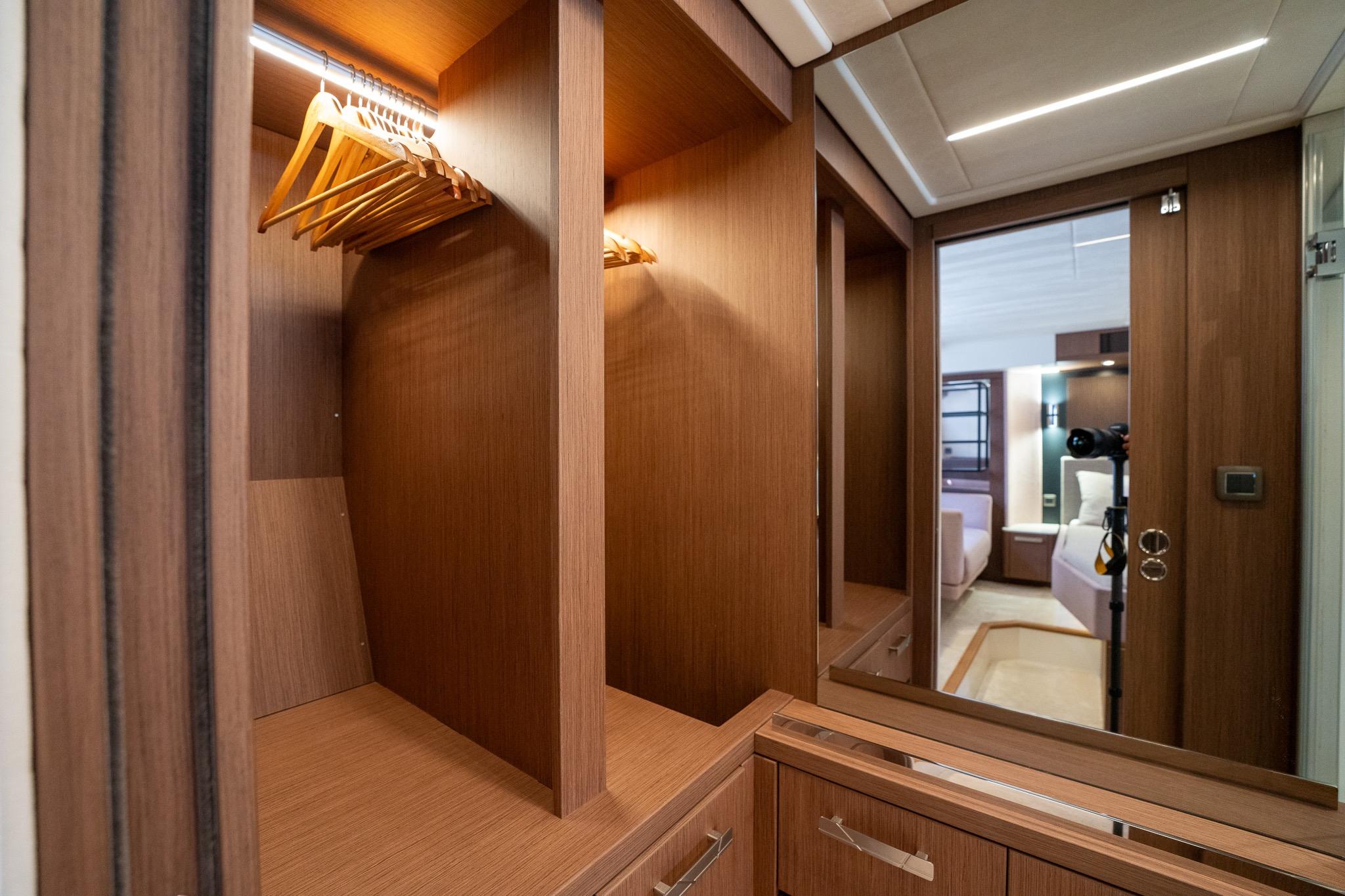 Luxurious wooden wardrobe interior in 2023 Prestige X60 yacht cabin.