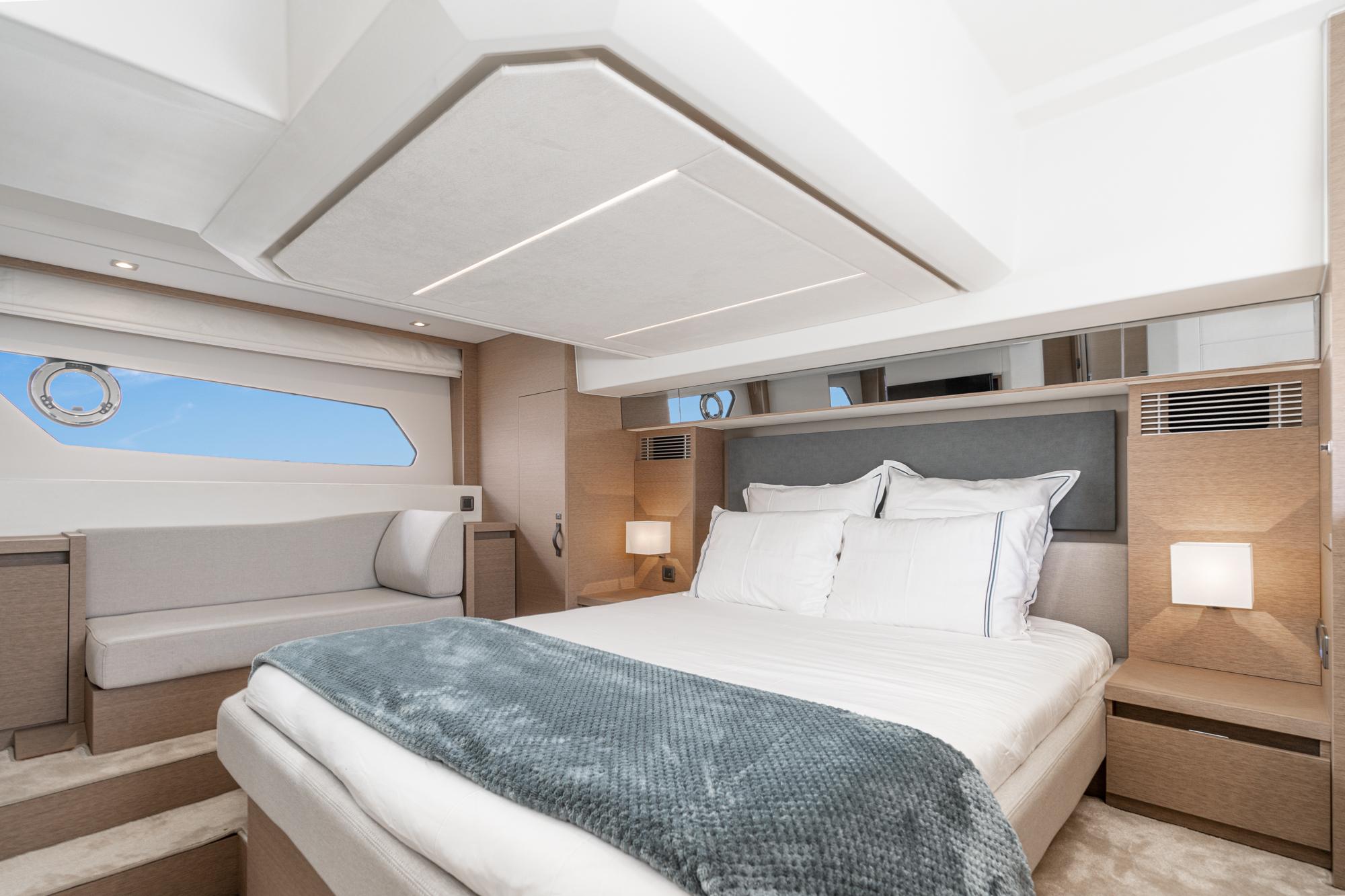 Luxurious bedroom interior of 2022 Prestige 460 yacht with modern design.