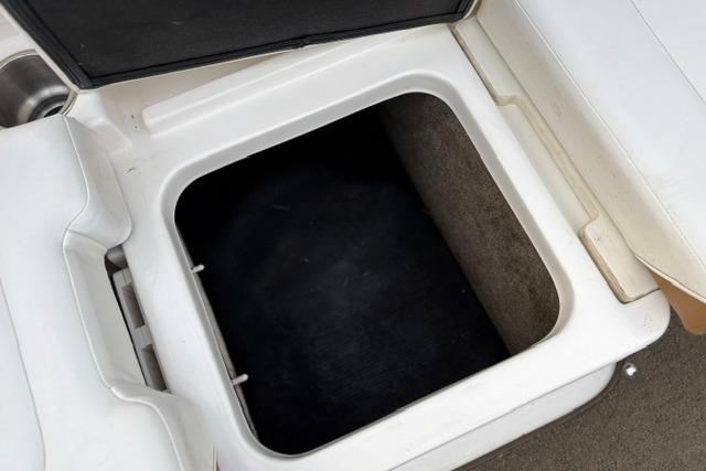 Open storage compartment on a 2017 Searay SPX210 boat.