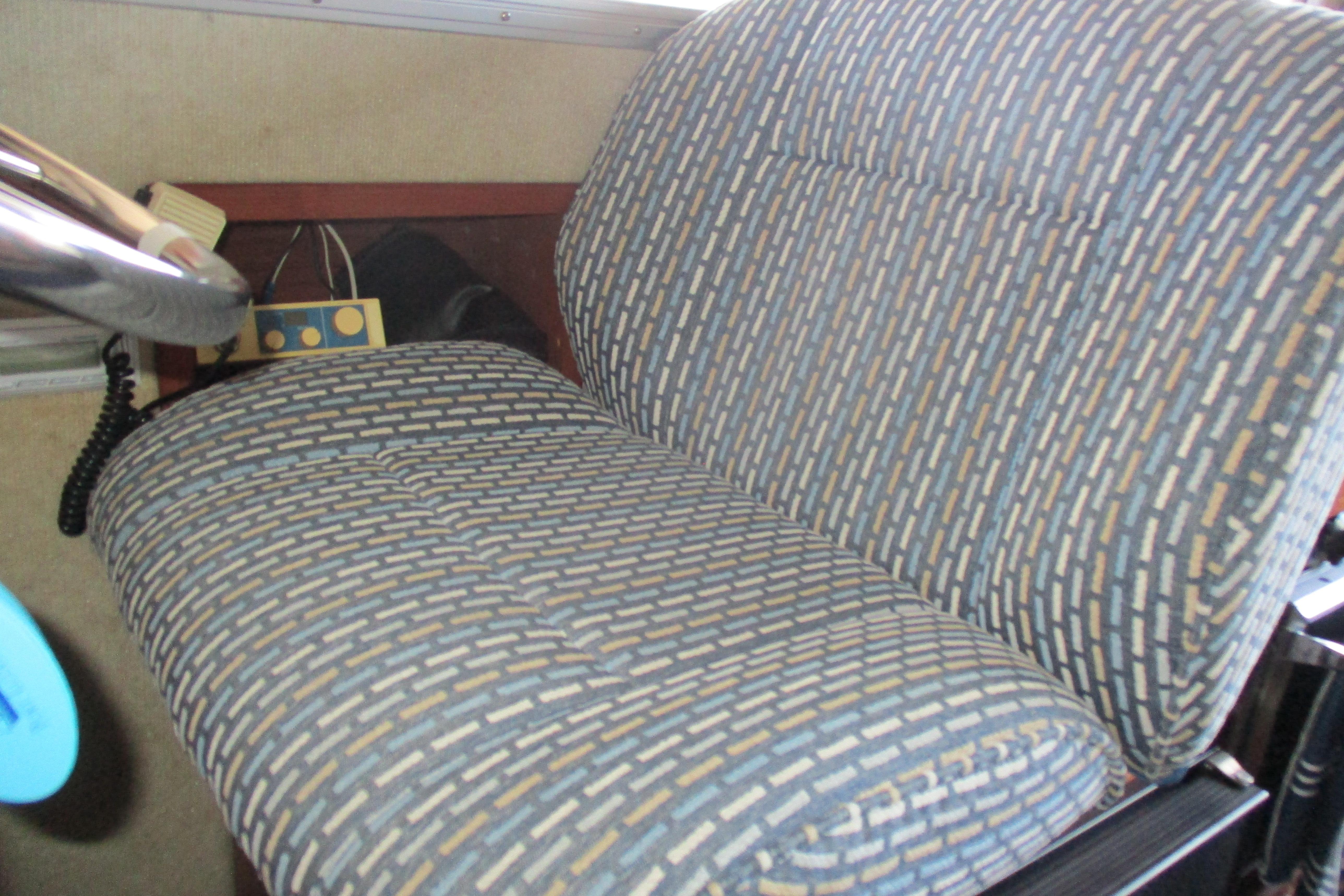 1988 Commander 26 interior seat with patterned upholstery and steering wheel.