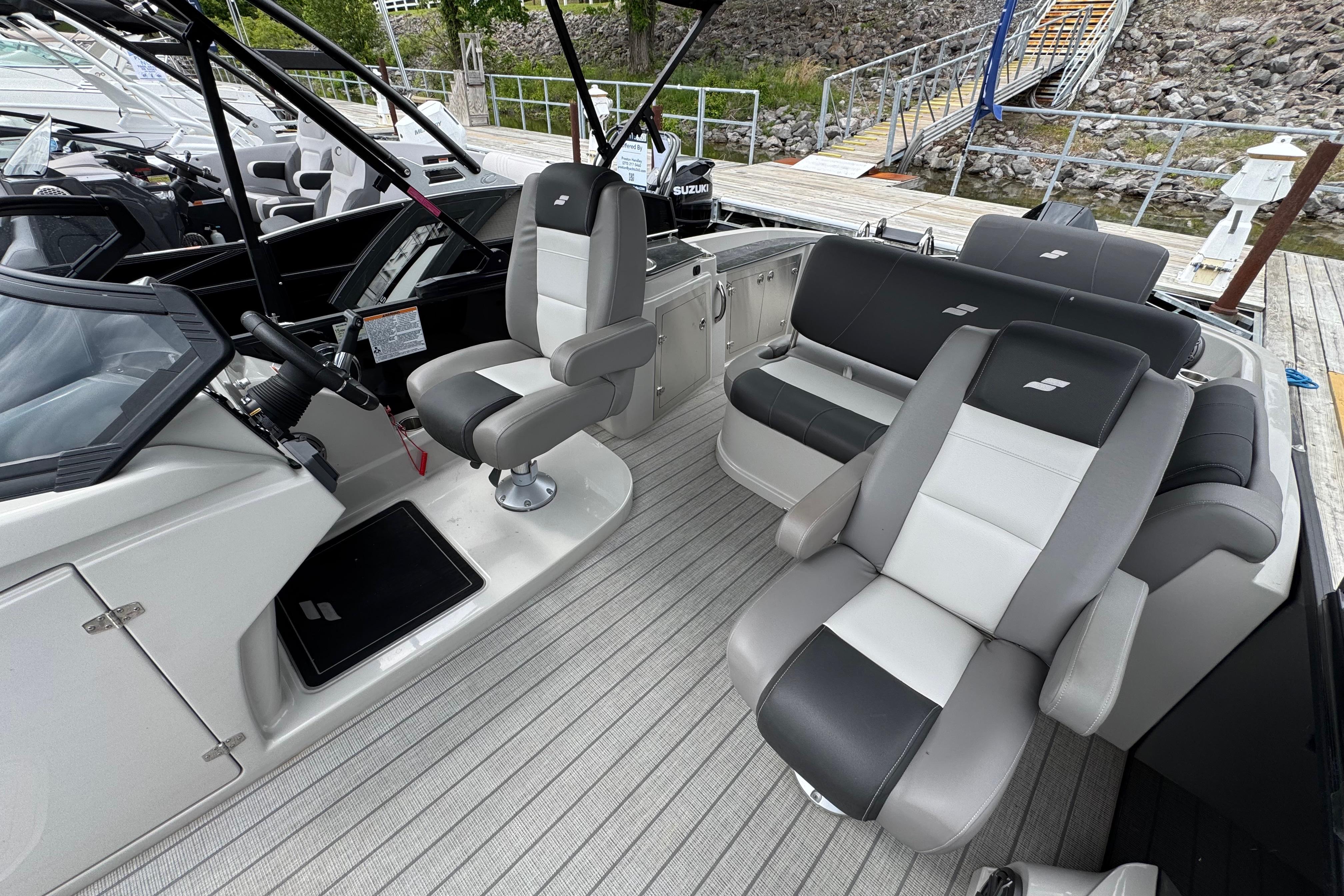 2023 Starcraft MX 25 DL DH boat interior with modern seating and steering wheel.