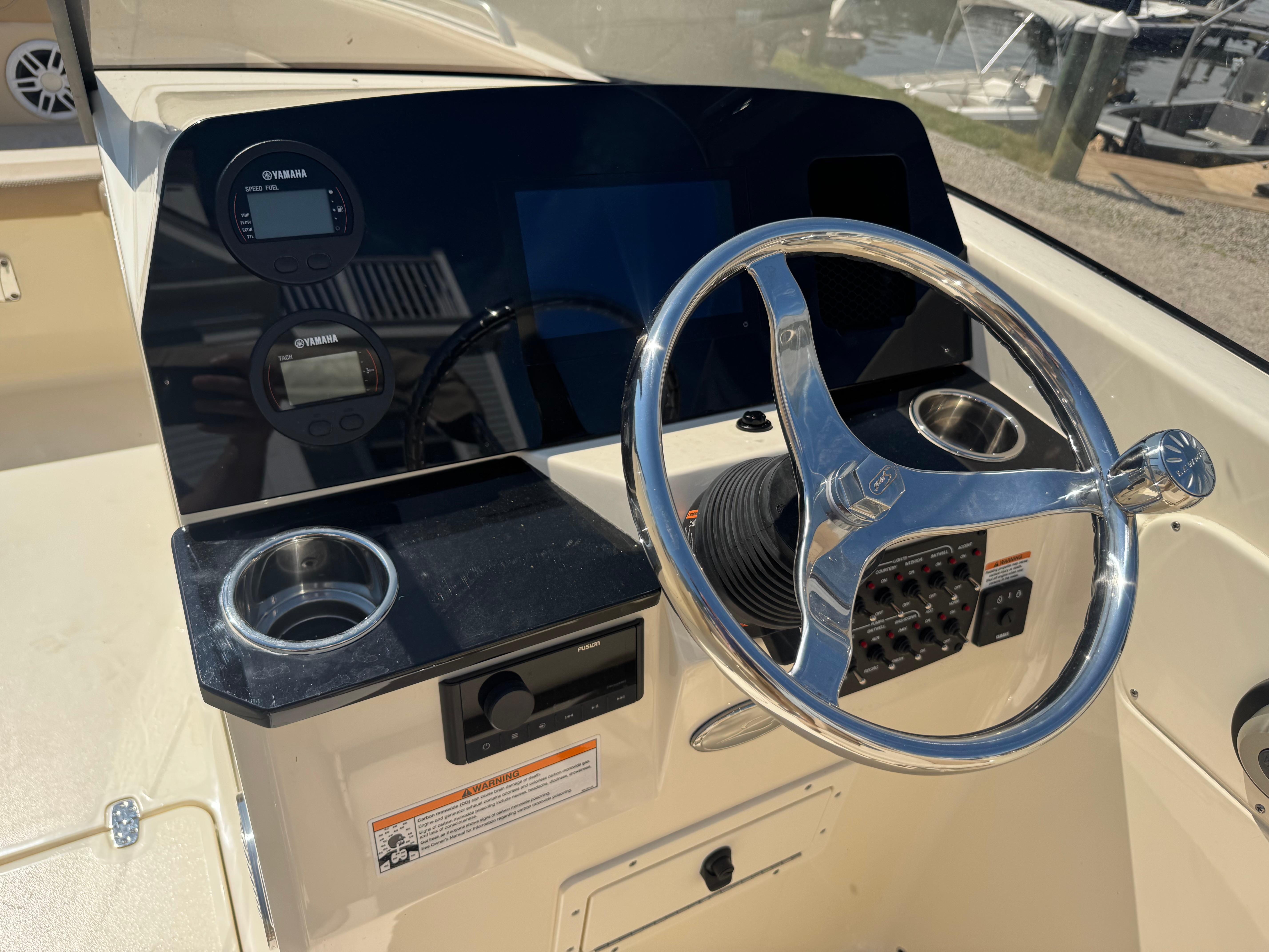 2025 Scout 215 Dorado boat dashboard with steering wheel and Yamaha controls.