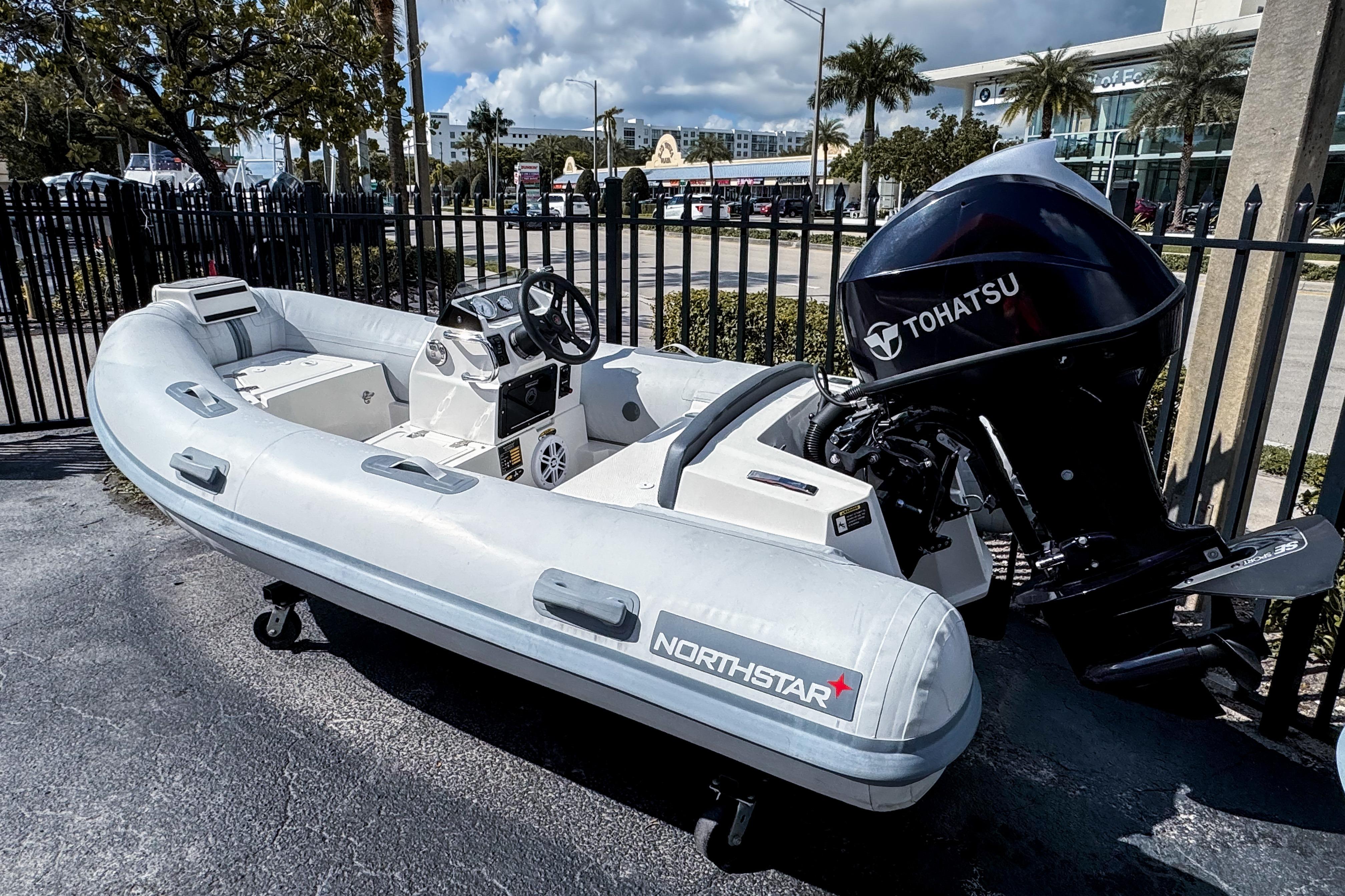 2021 Northstar Axis 3.4 inflatable boat with Tohatsu outboard motor, parked outdoors.