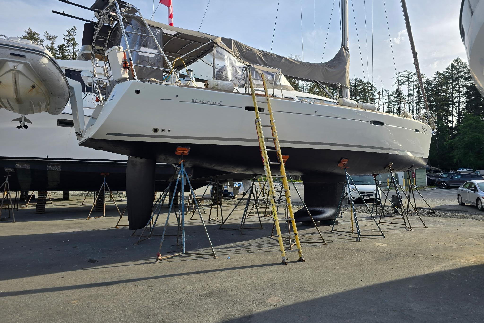2007 Beneteau Oceanis 49 sailboat on stands, ready for maintenance in a boatyard.