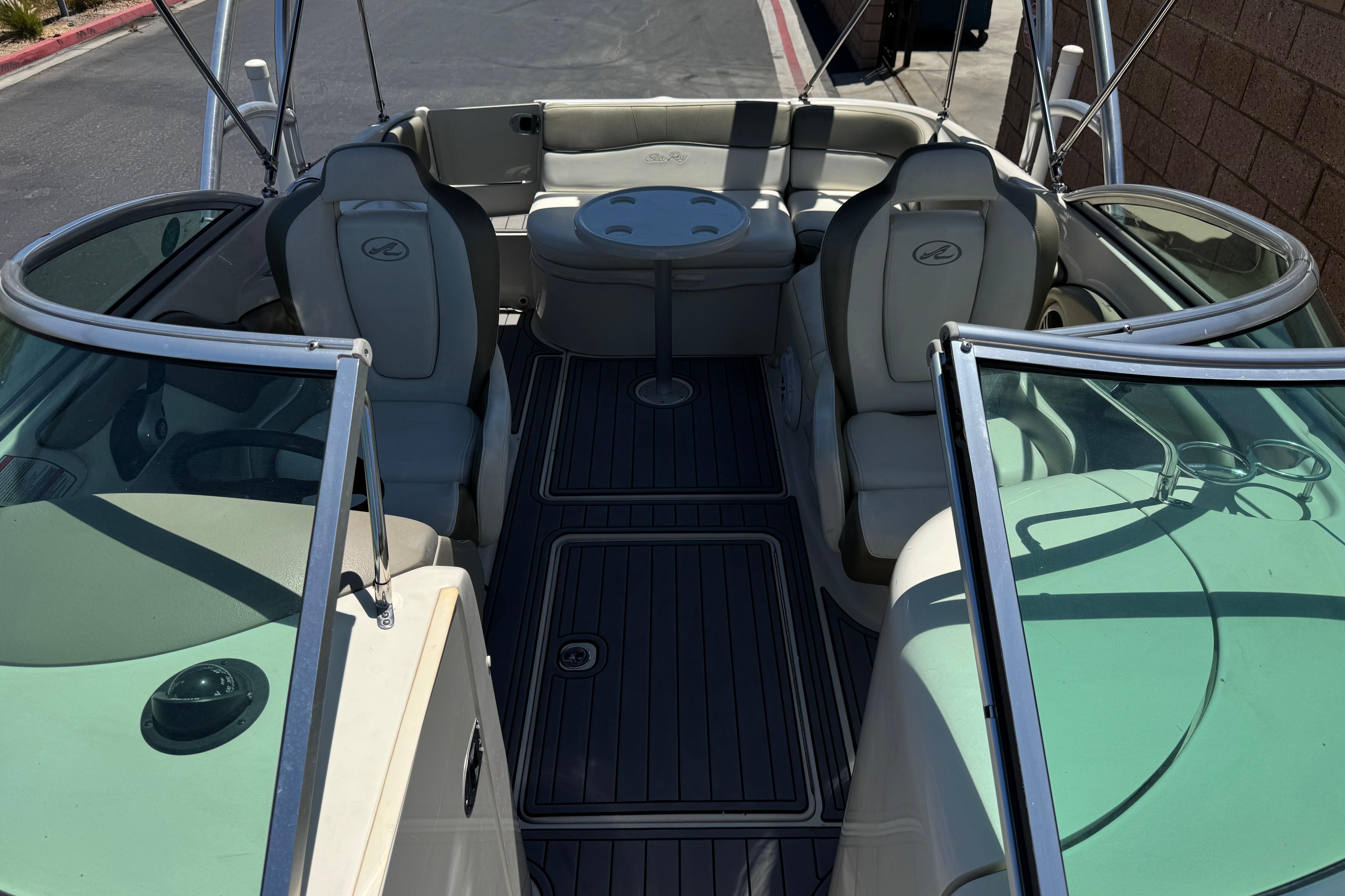 2007 Sea Ray 240 Sundeck interior with seating and table, showcasing spacious design.