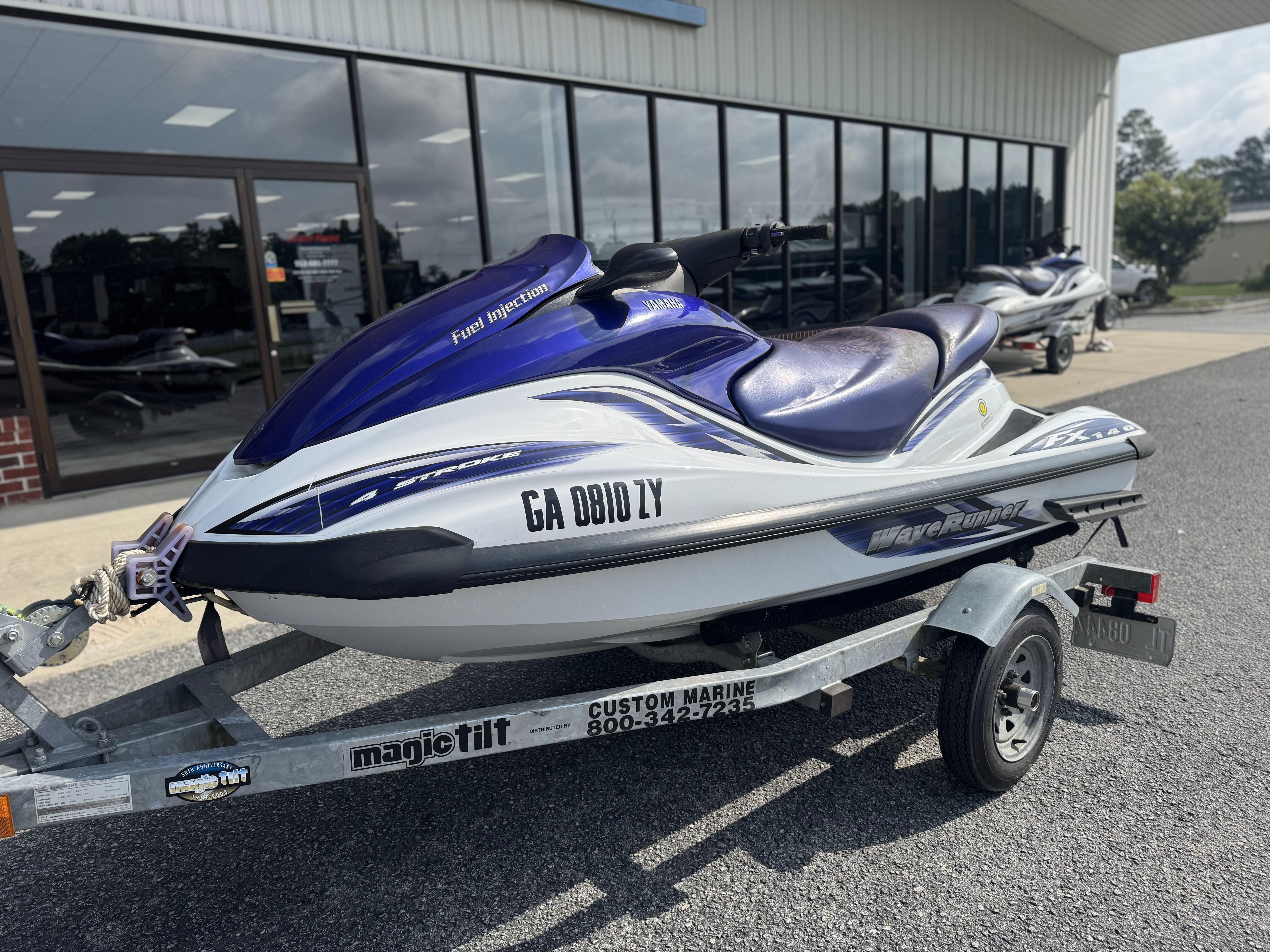 2003 Yamaha WaveRunner FX140 on trailer outside a marine shop.
