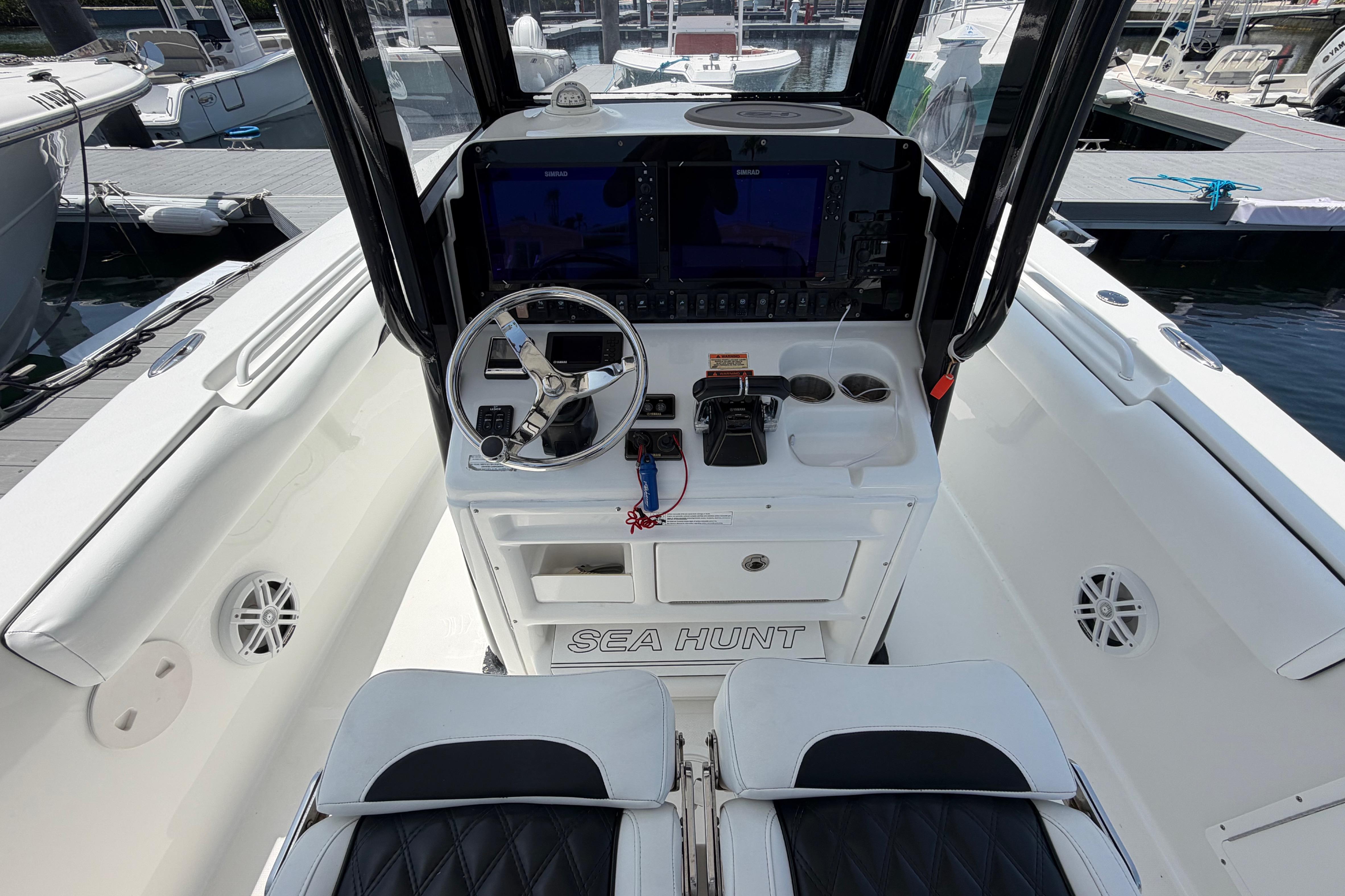 2019 Sea Hunt Gamefish 27 Coffin Box boat cockpit with steering wheel and controls.