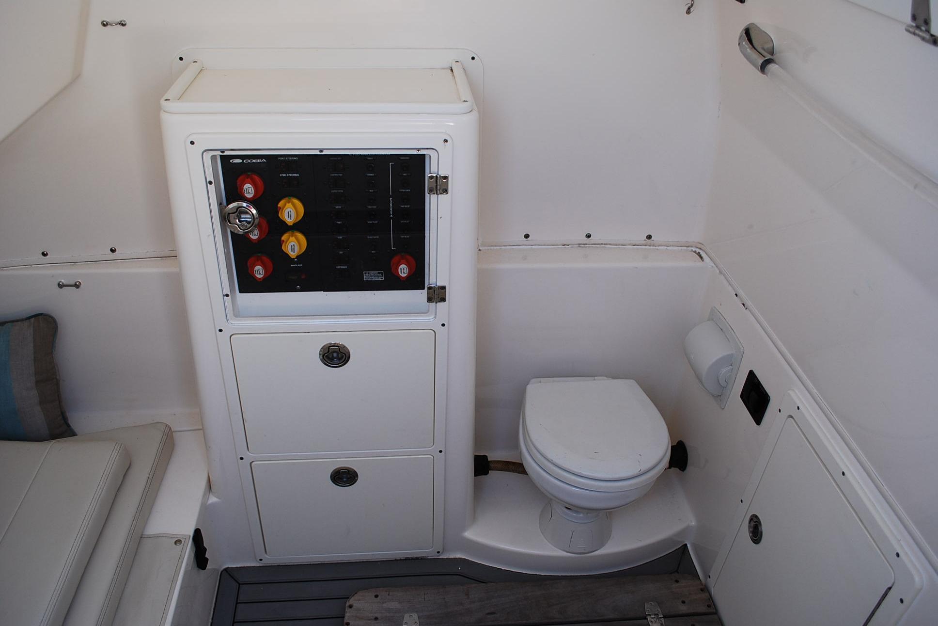 2019 Cobia 344 Center Console boat interior with control panel and toilet.