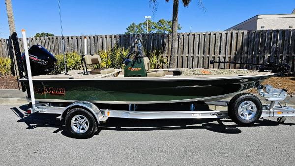 2025 Mako 18 Pro Skiff Backwater Edition on trailer, parked outdoors.