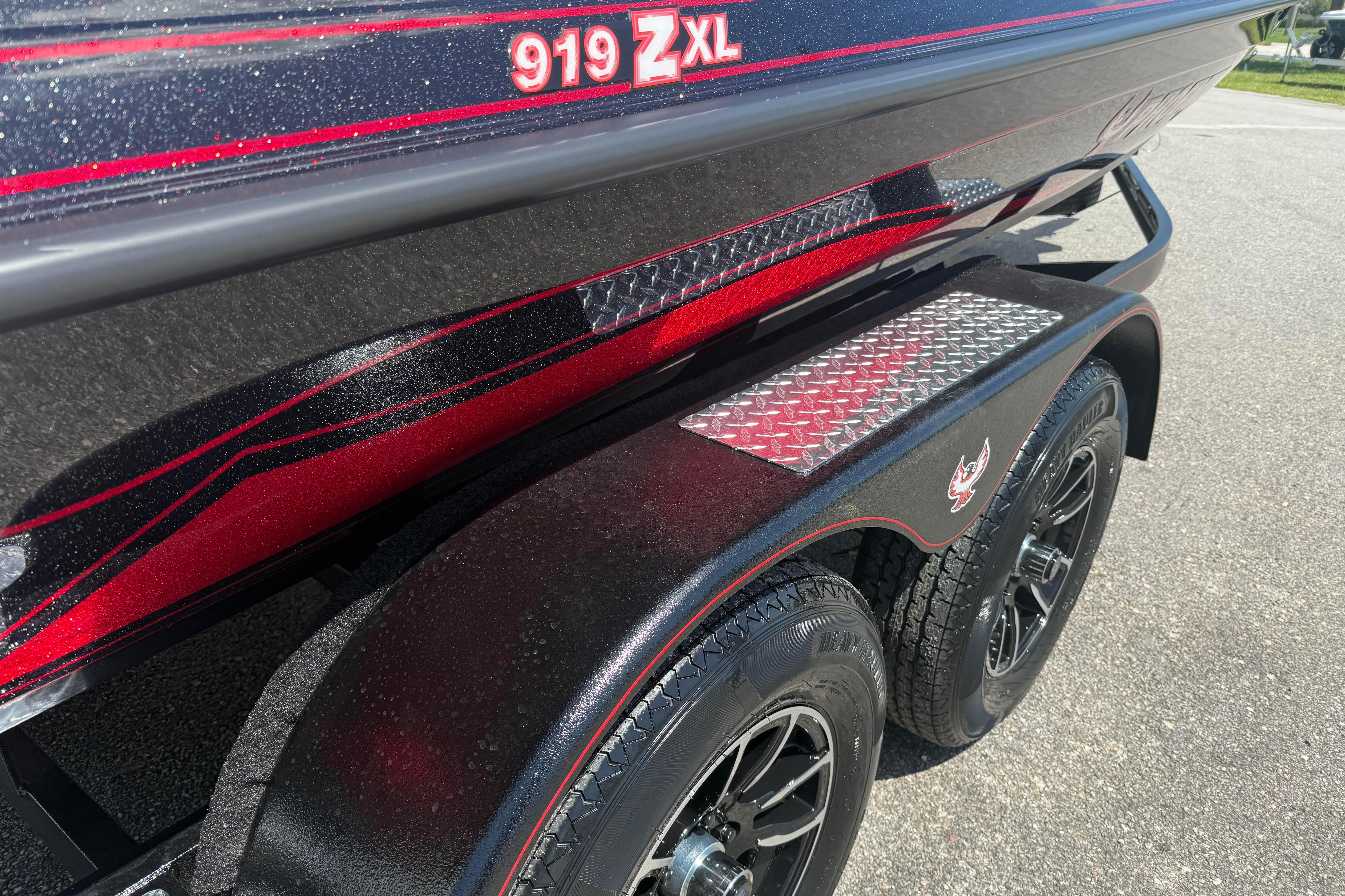 2027 Phoenix 919 ZXL boat trailer with red and black detailing, parked on pavement.