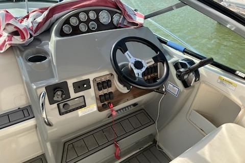 2012 Bayliner 285 Cruiser helm with steering wheel and control panel.