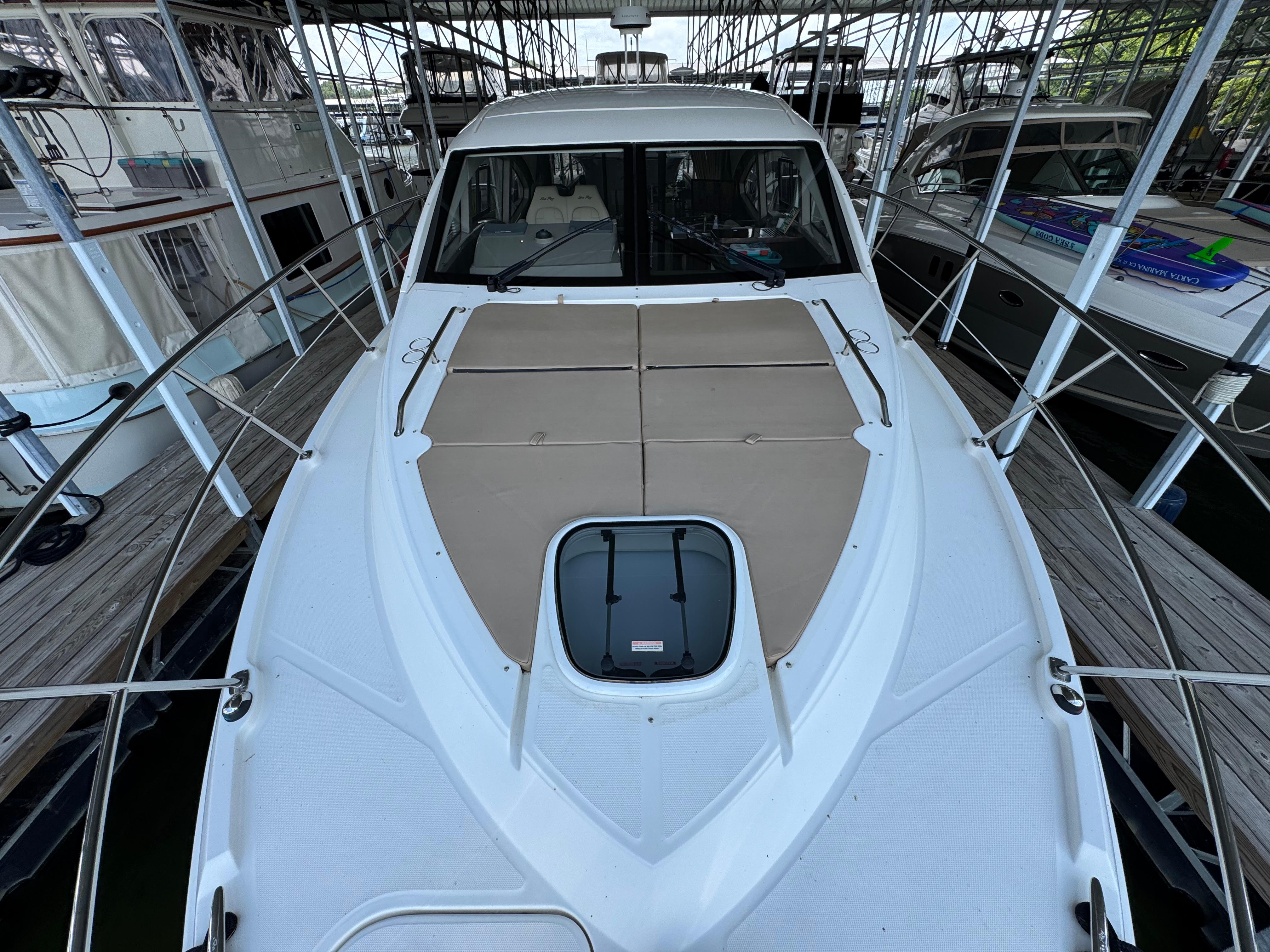 2017 Sea Ray Sundancer 400 yacht docked, featuring spacious deck and sleek design.