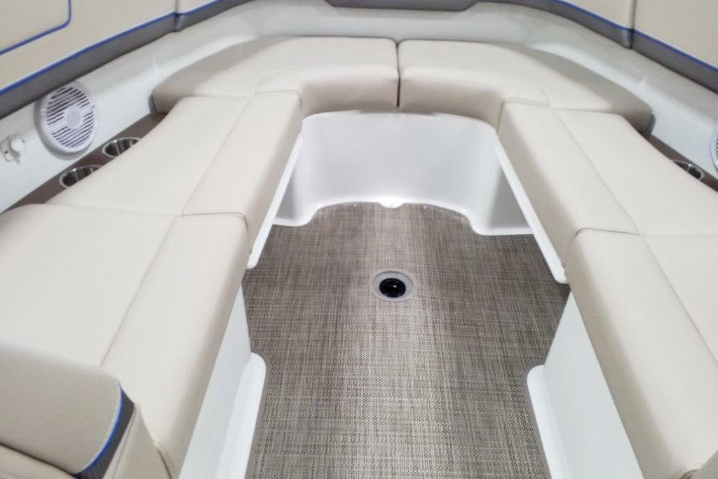 2019 Formula 310 Bowrider interior with beige seating and carpeted flooring.