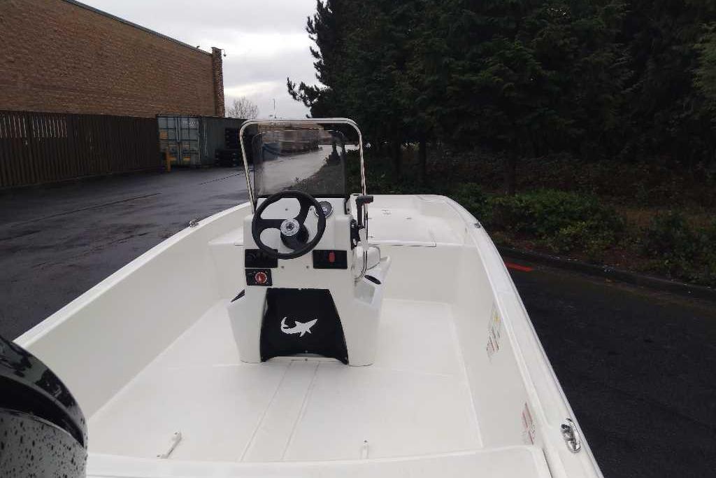 2026 Mako Pro Skiff 17 CC boat with center console, parked outdoors.