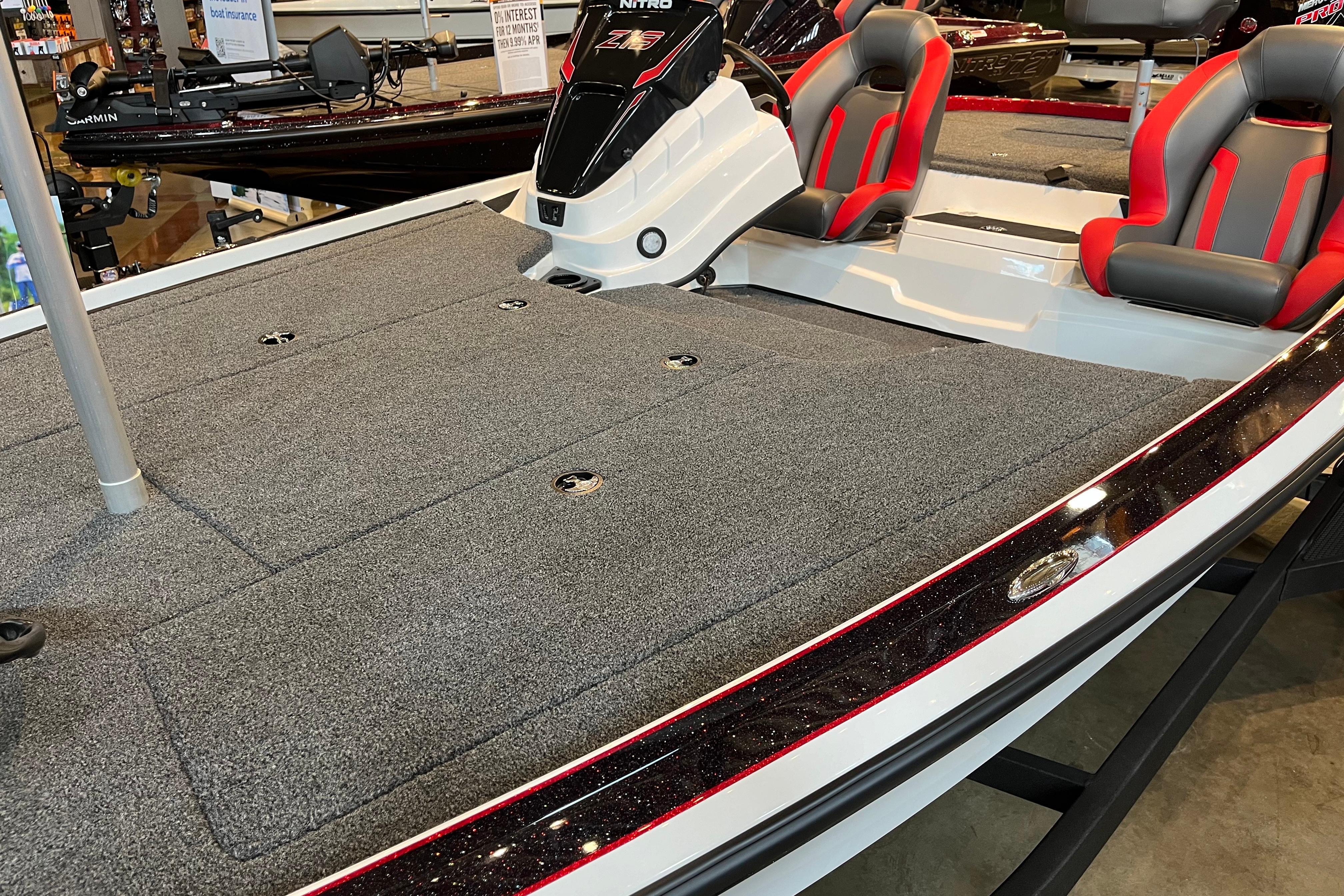 2025 Nitro Z19 boat with gray carpeted deck and red-accented seats on display.