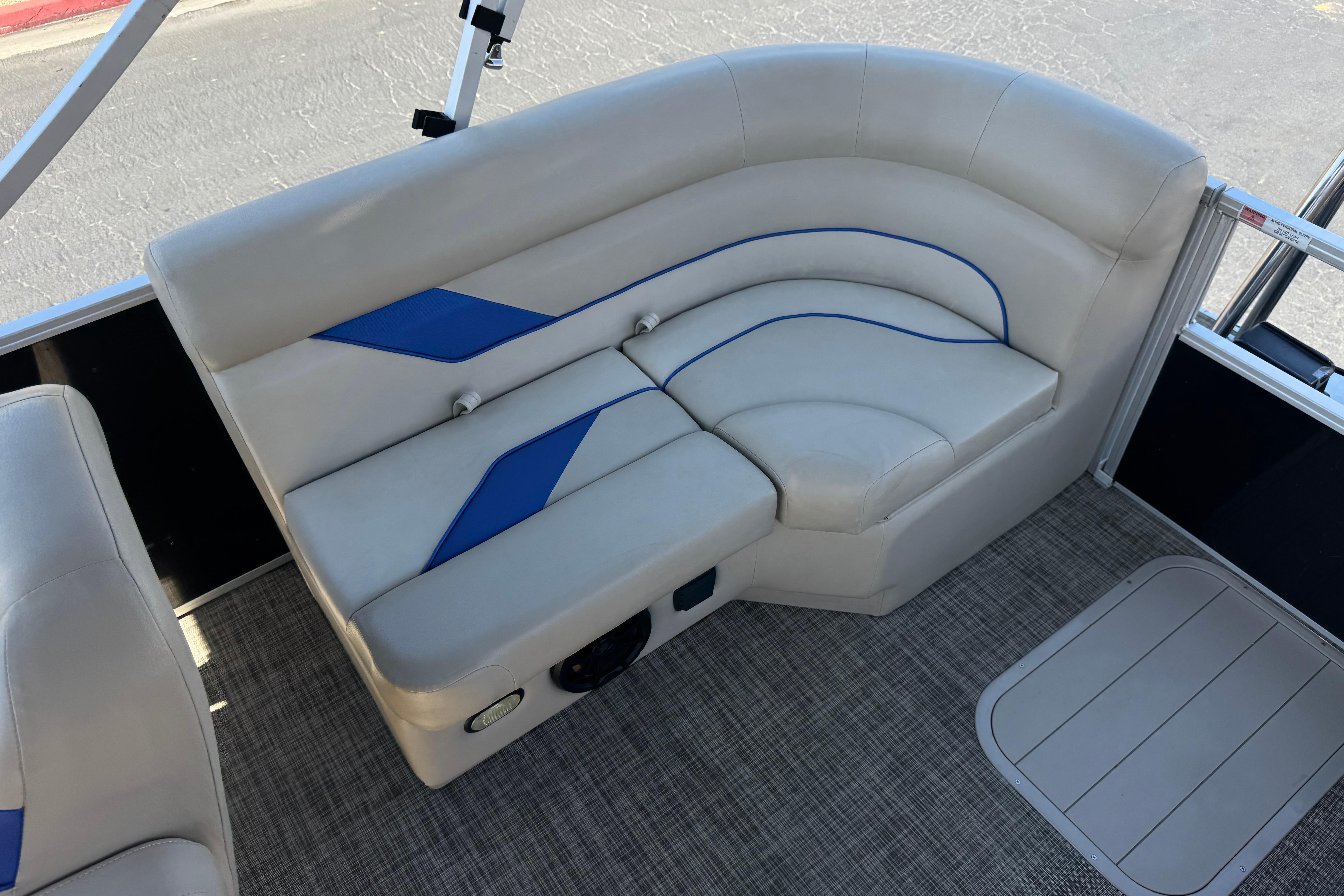 2021 SunCatcher Select 20RCX boat interior with beige and blue cushioned seating.