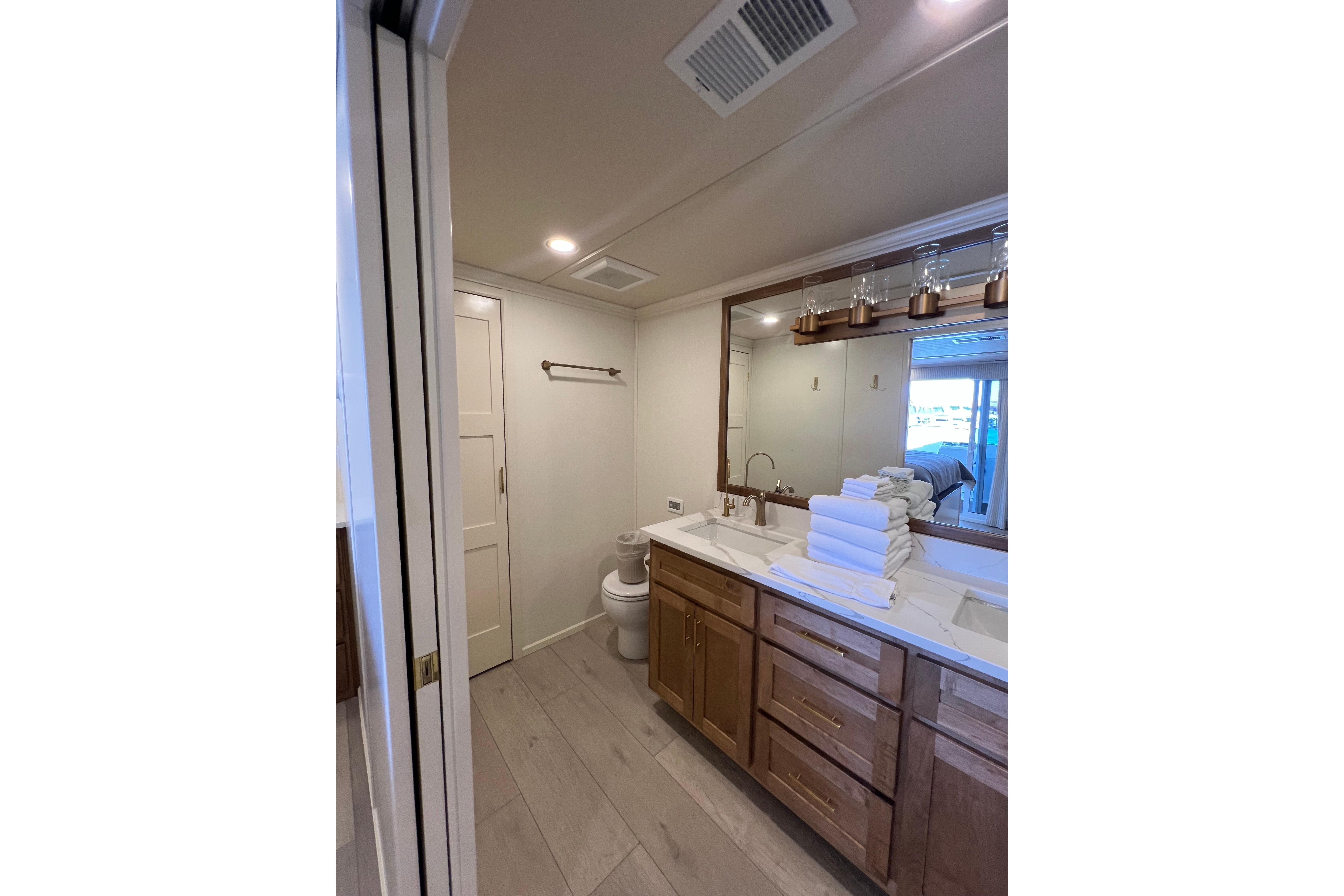 Modern bathroom in 2025 Sumerset Excellence Multiple Shares houseboat, featuring dual sinks and wooden cabinetry.