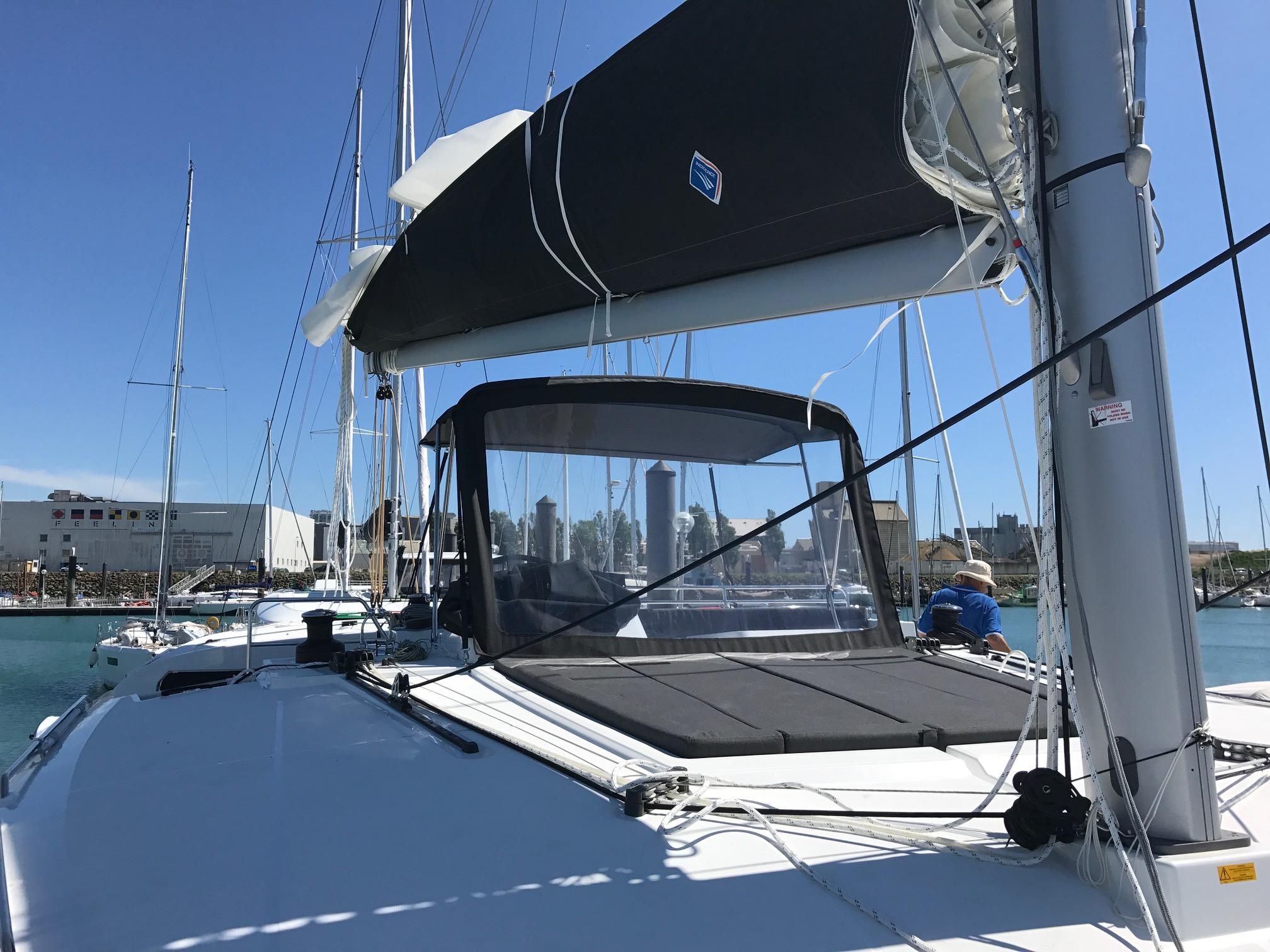 2017 Lagoon 450 F catamaran docked in marina, featuring sleek design and spacious deck.