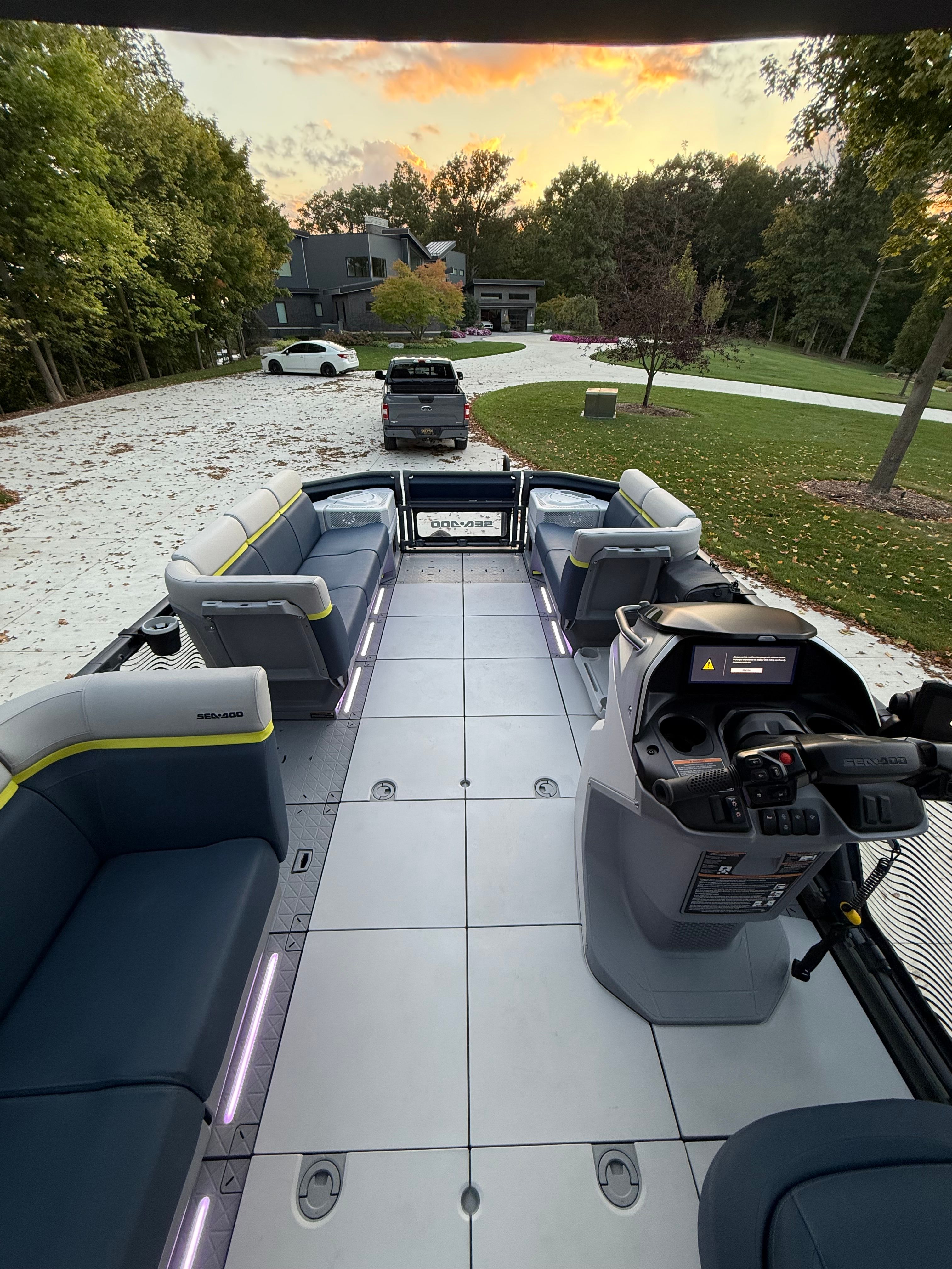 The image shows the interior of a 2025 Sea-Doo Switch Cruise Limited 21. It features spacious seating and a modern helm.