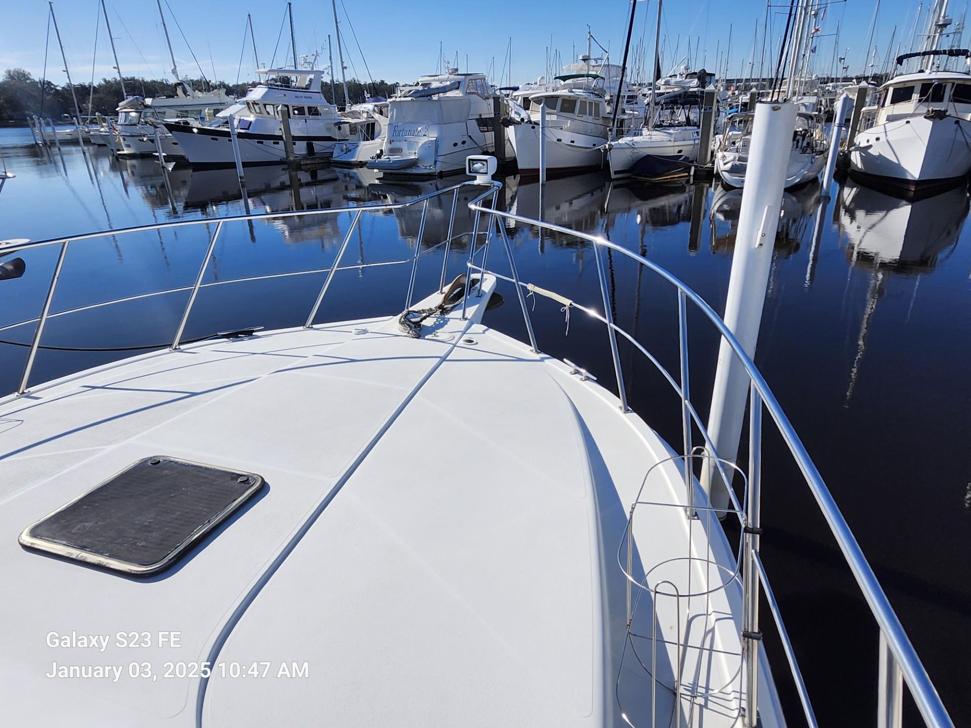 1999 Navigator 4800 CLASSIC yacht docked in a marina with other boats.