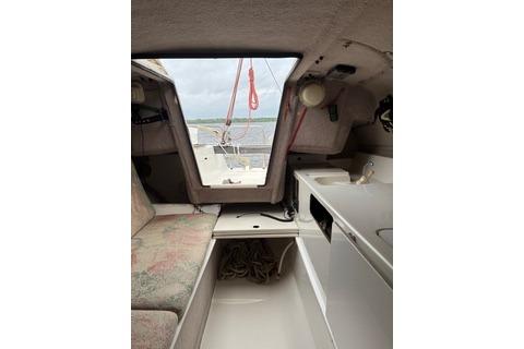 Interior of 1994 Corsair F24 MKI sailboat with seating and compact kitchenette.