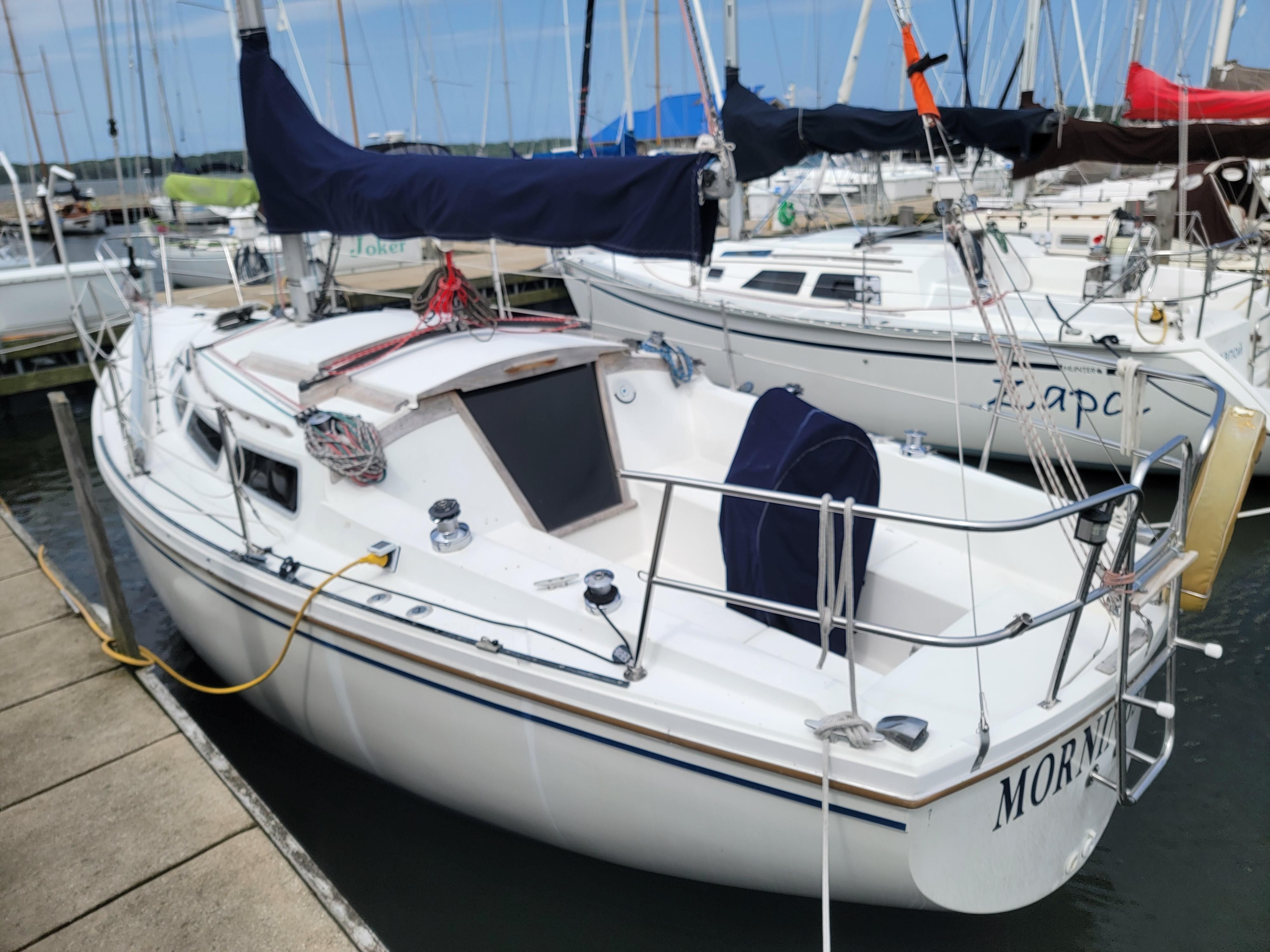 1984 Catalina 30 sailboat docked in marina.