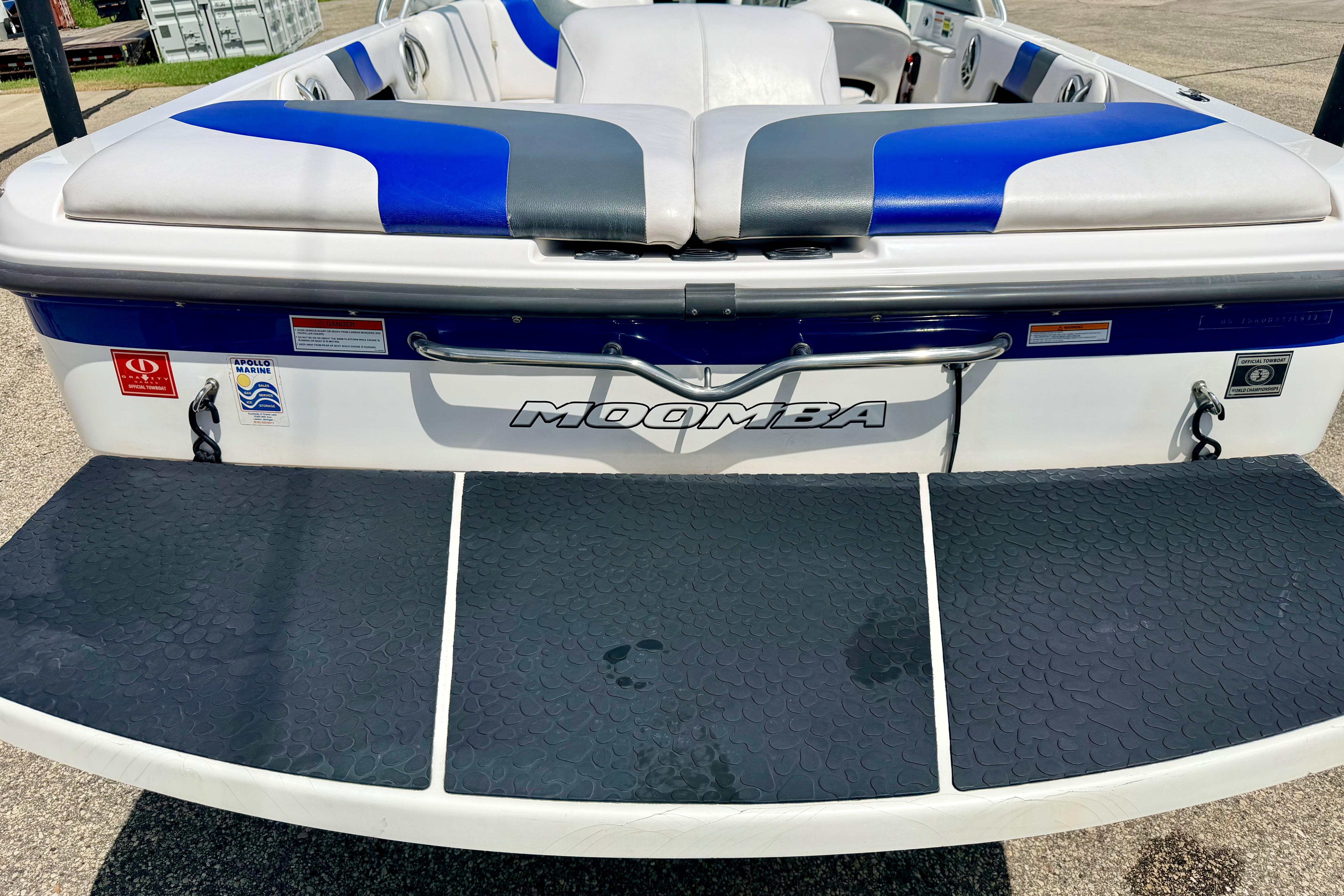 2008 Moomba Outback V boat with blue and gray seating, rear view.