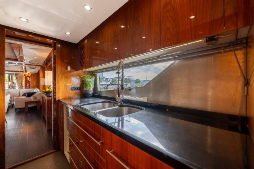 Luxurious kitchen interior of 2009 Sunseeker 34 Metre Yacht with sleek wood finishes.