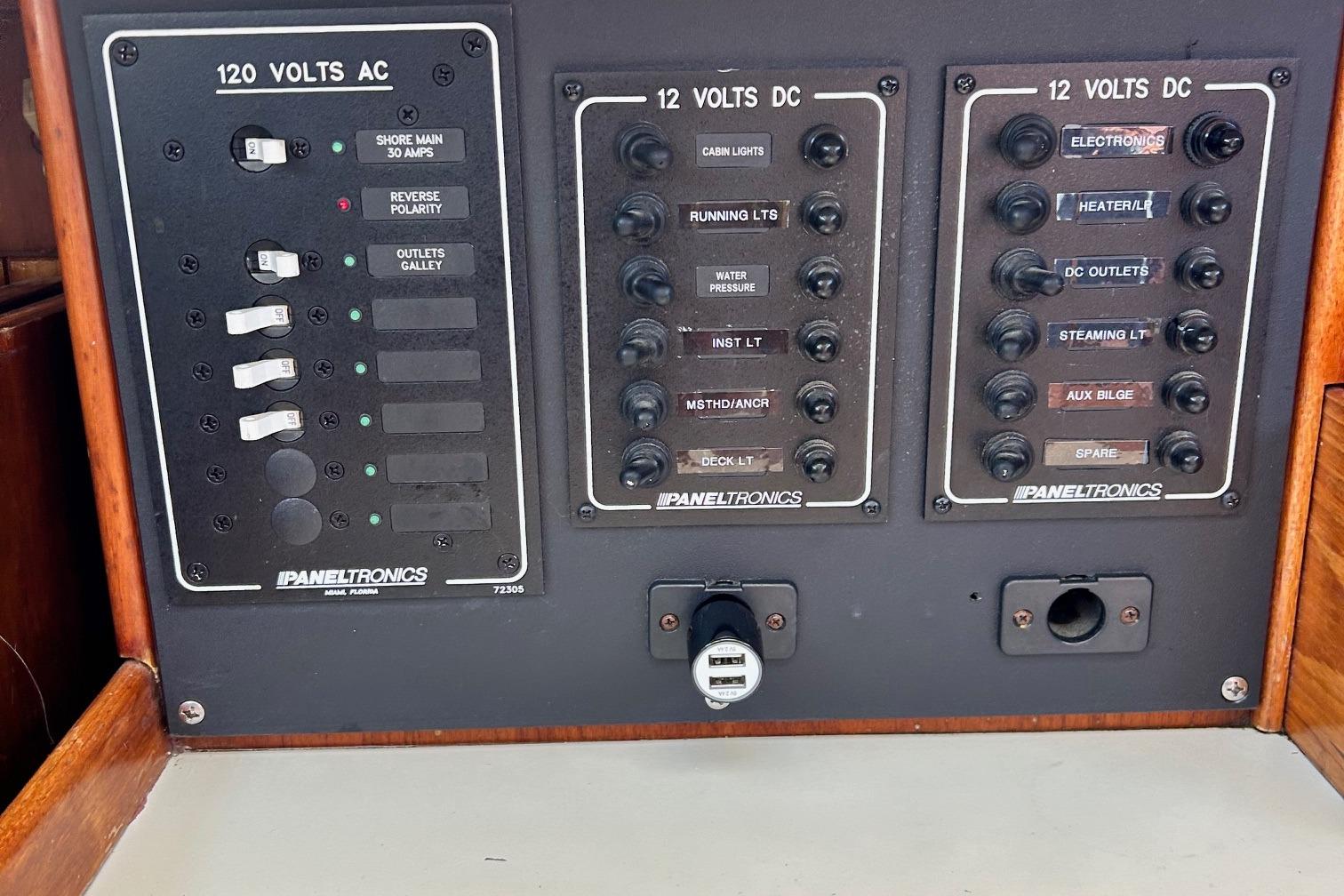 Electrical panel of a 1967 LeComte Northeast 38 boat, featuring 120V AC and 12V DC controls.