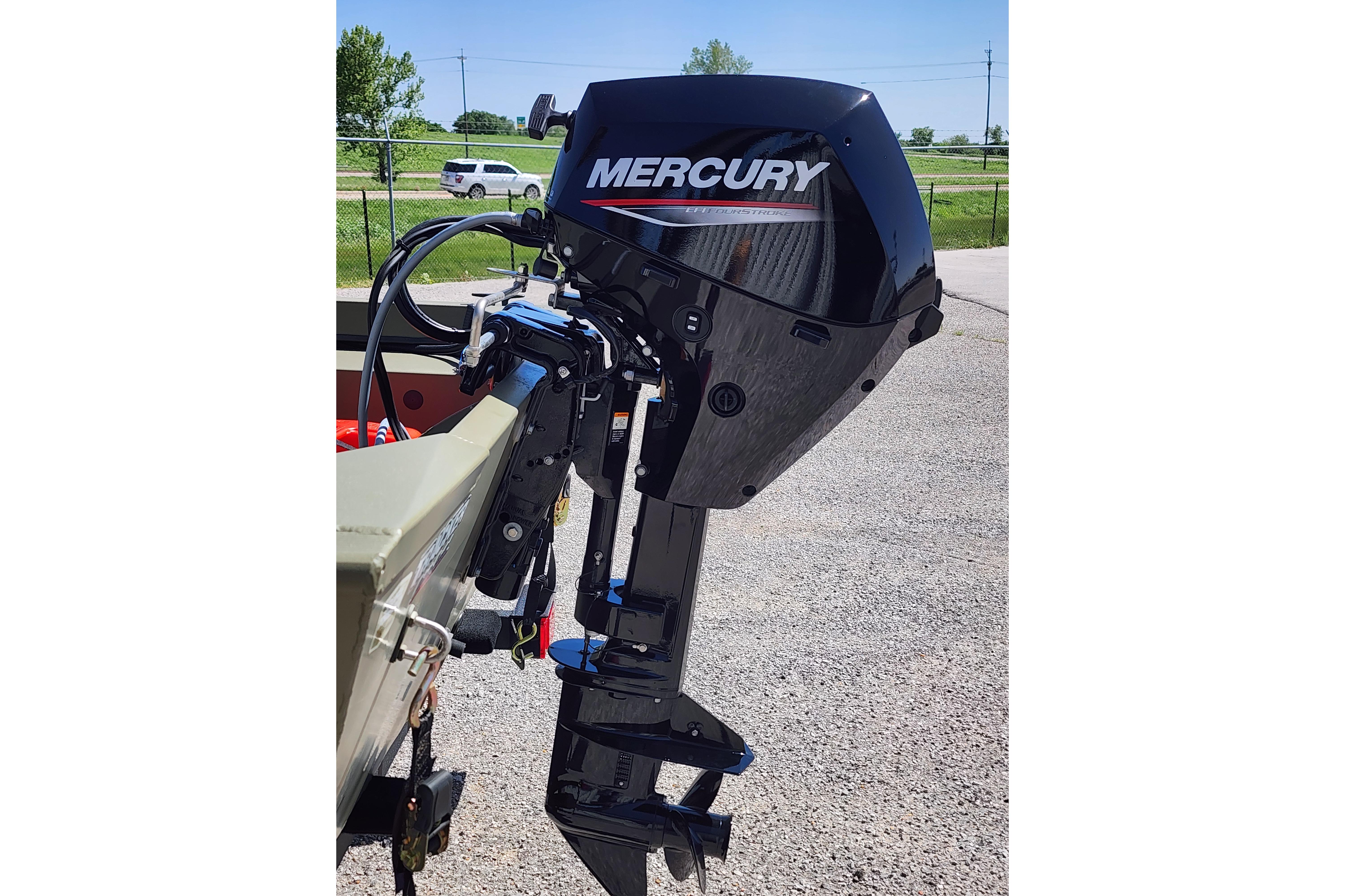 2026 Tracker Grizzly 1648 SC with Mercury outboard motor in a parking lot.