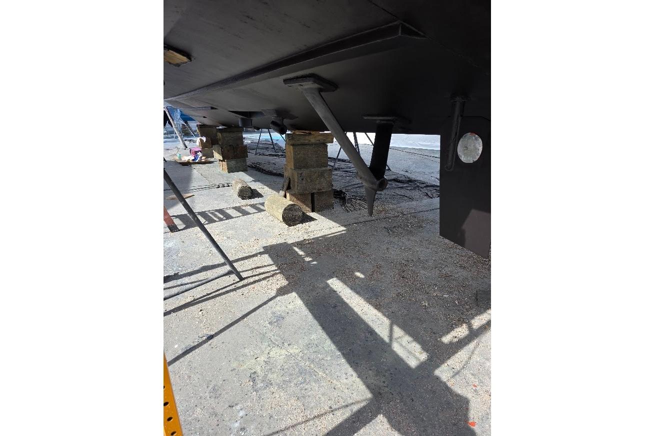 Underneath view of a 1993 McKinna 48 Pilothouse boat on dry dock.