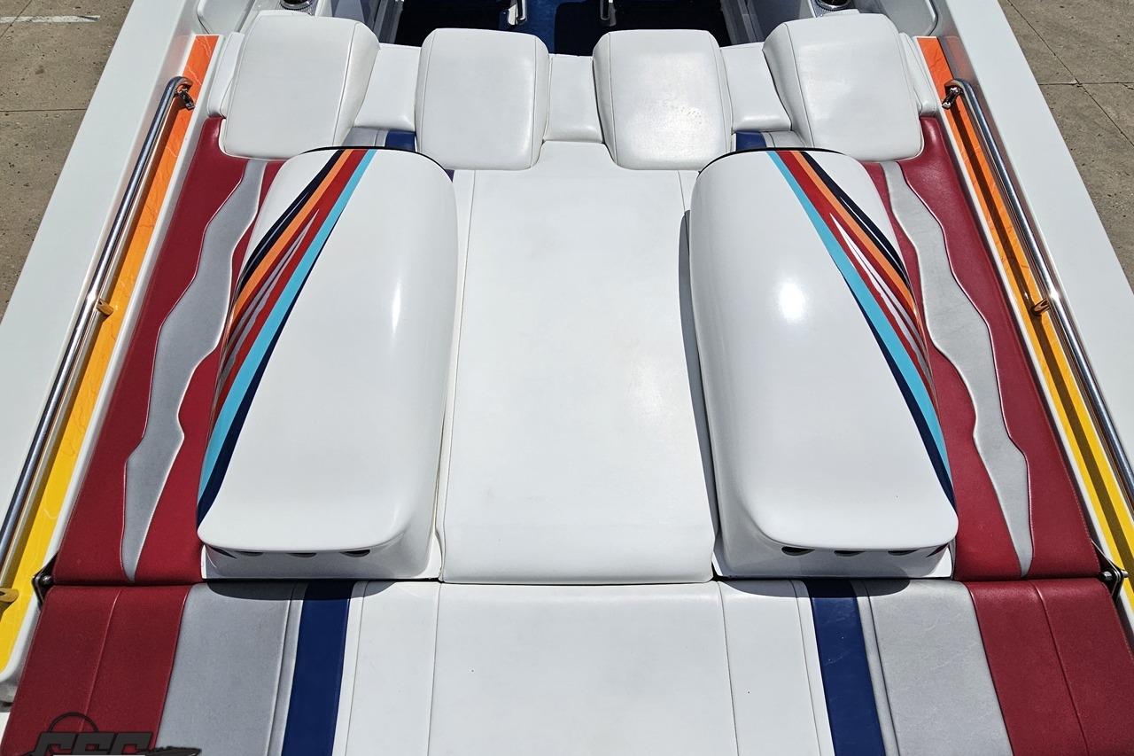 2002 Formula 382 FASTech boat interior with colorful striped upholstery design.