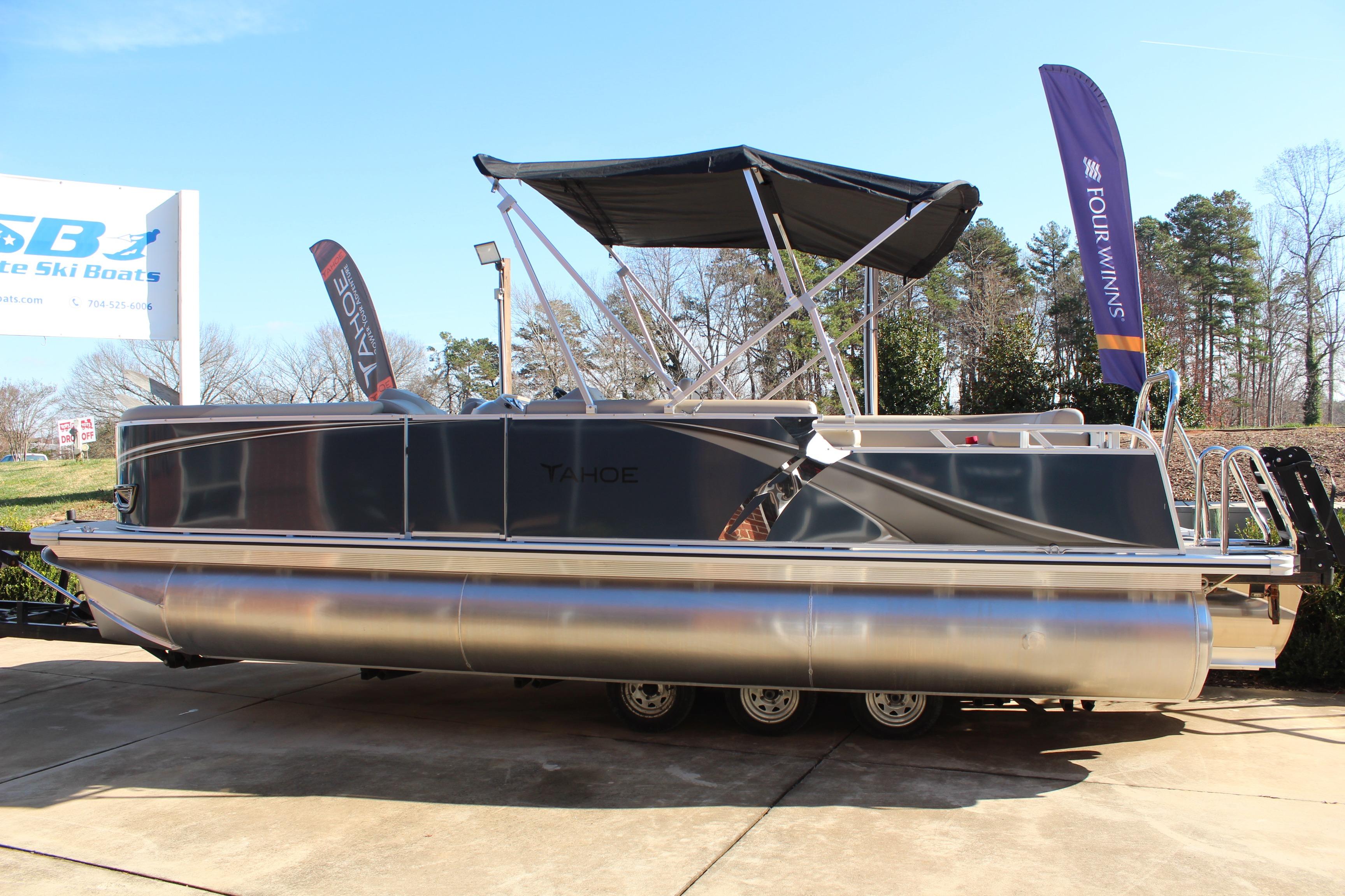 2026 Tahoe Pontoon LTZ Elite boat displayed outdoors with canopy and banners.