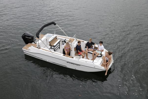 2025 Starcraft SVX 211 OB CC boat with passengers on calm water.