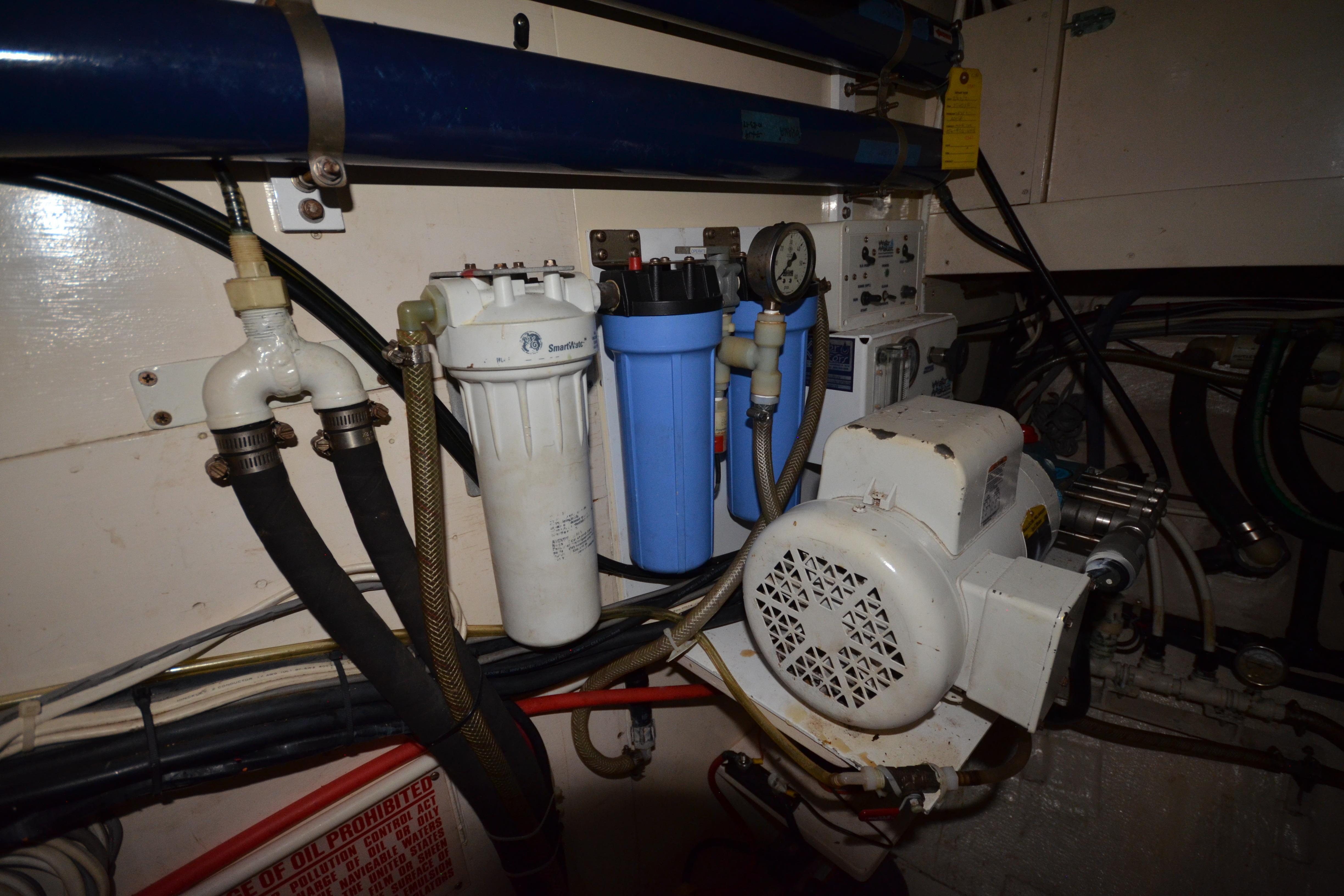 Engine room of 1992 Hinckley Sou'wester 59 yacht with filtration system and machinery.