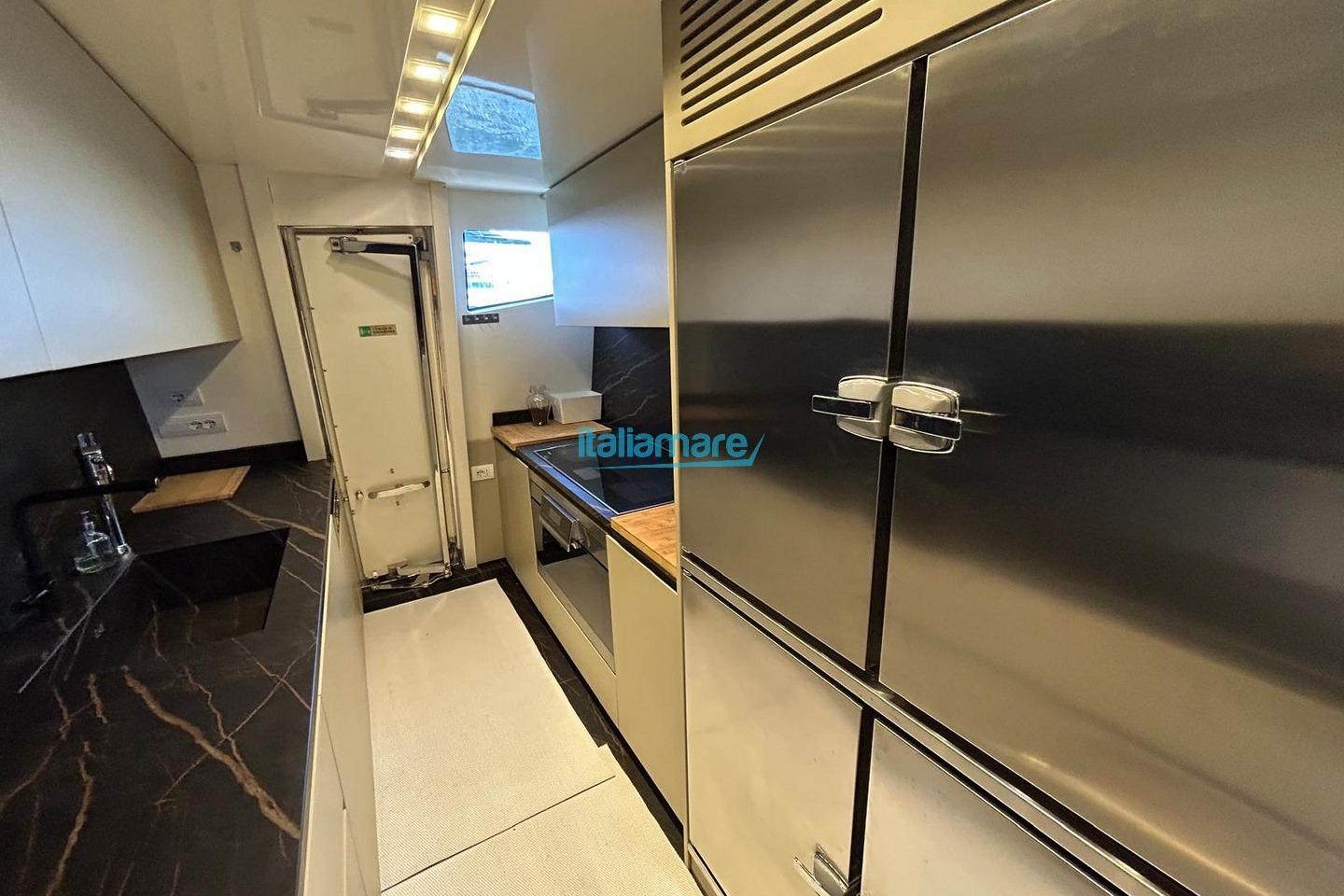 Luxurious kitchen interior of 2009 PerMare Amer 92 yacht with modern appliances.
