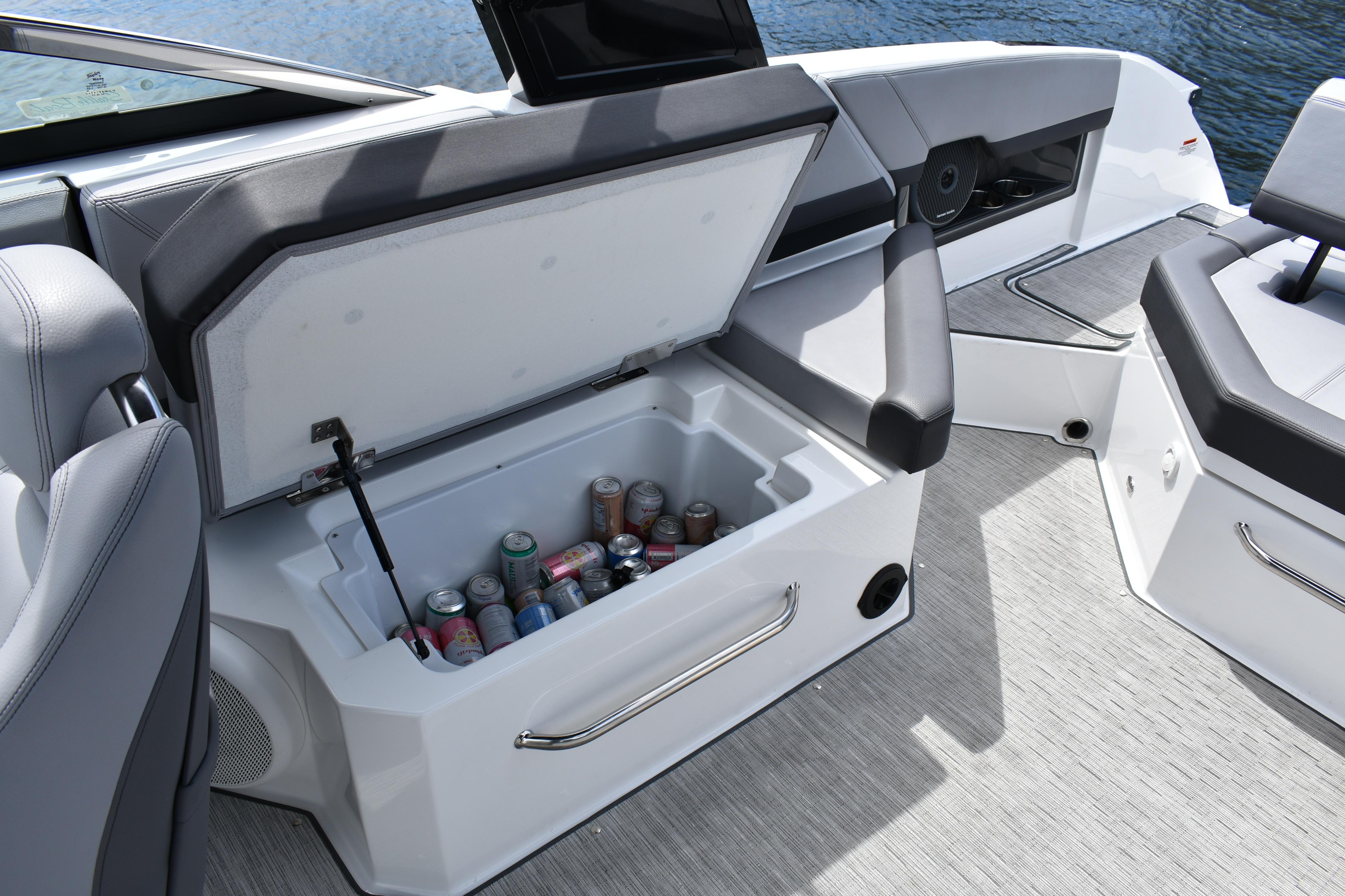 2023 Cobalt R8 boat interior with open cooler, stocked with assorted beverages.