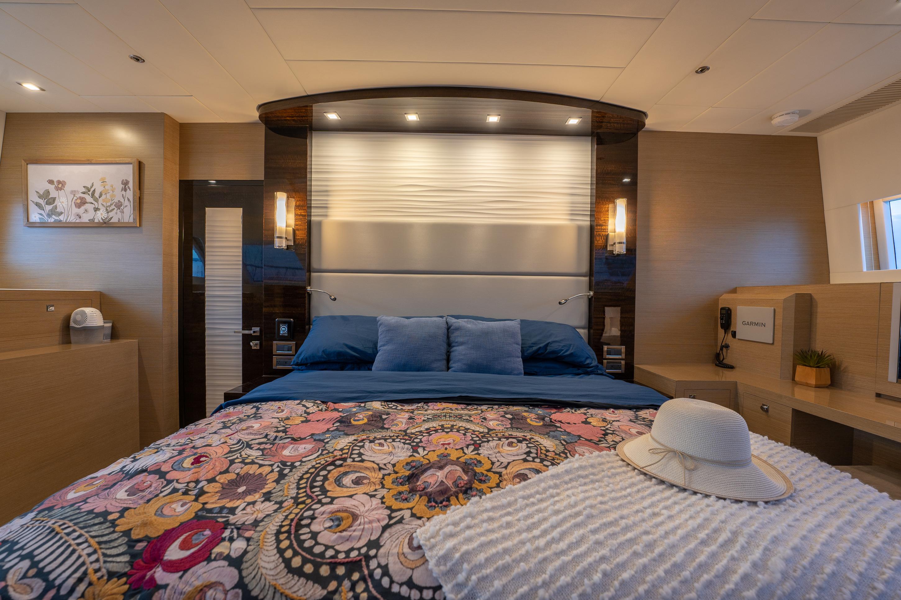 Luxurious bedroom interior of 2020 Horizon PC60 yacht with elegant decor and ambient lighting.