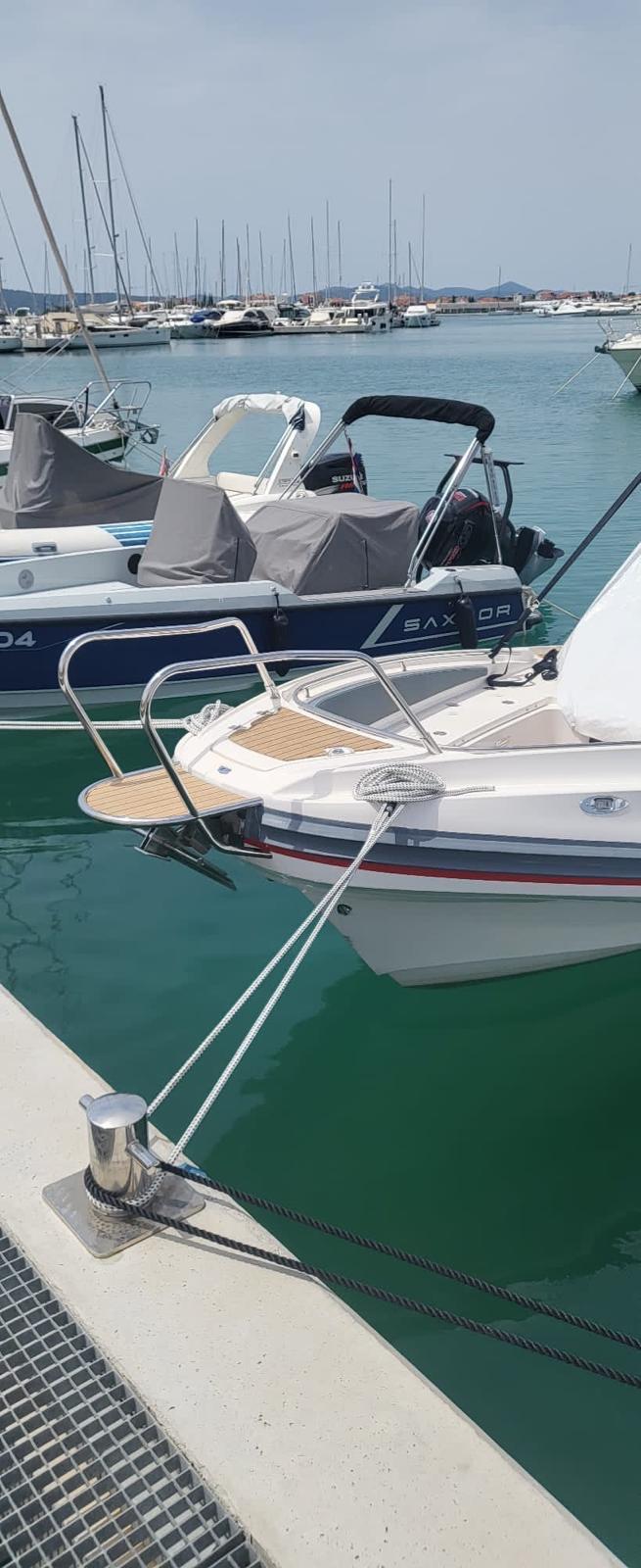 2020 Zar 85 SL boat docked in a marina with calm waters.